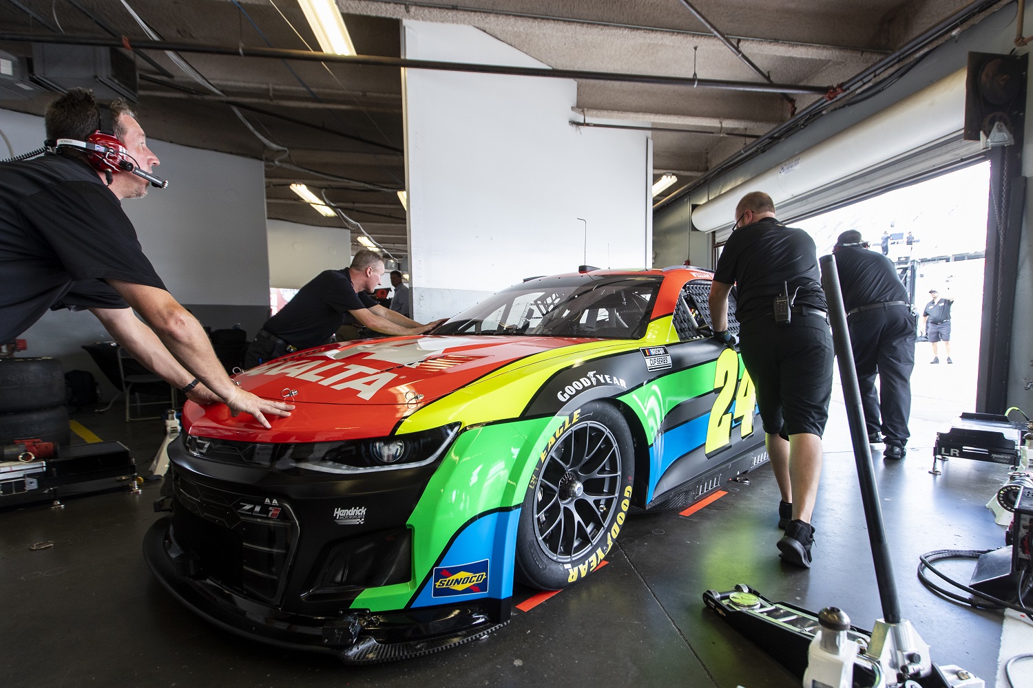Team members push the No. 24 NASCAR Next Gen car driven by William Byron out of the garage during the NASCAR Cup Series test at Daytona International Speedway on Sept. 7, 2021.