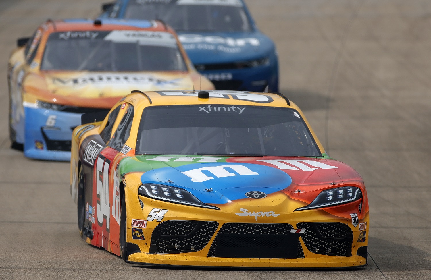 Kyle Busch, driver of the M&M's Toyota, leads the field during the NASCAR Xfinity Series Tennessee Lottery 250 at Nashville Superspeedway on June 19, 2021.