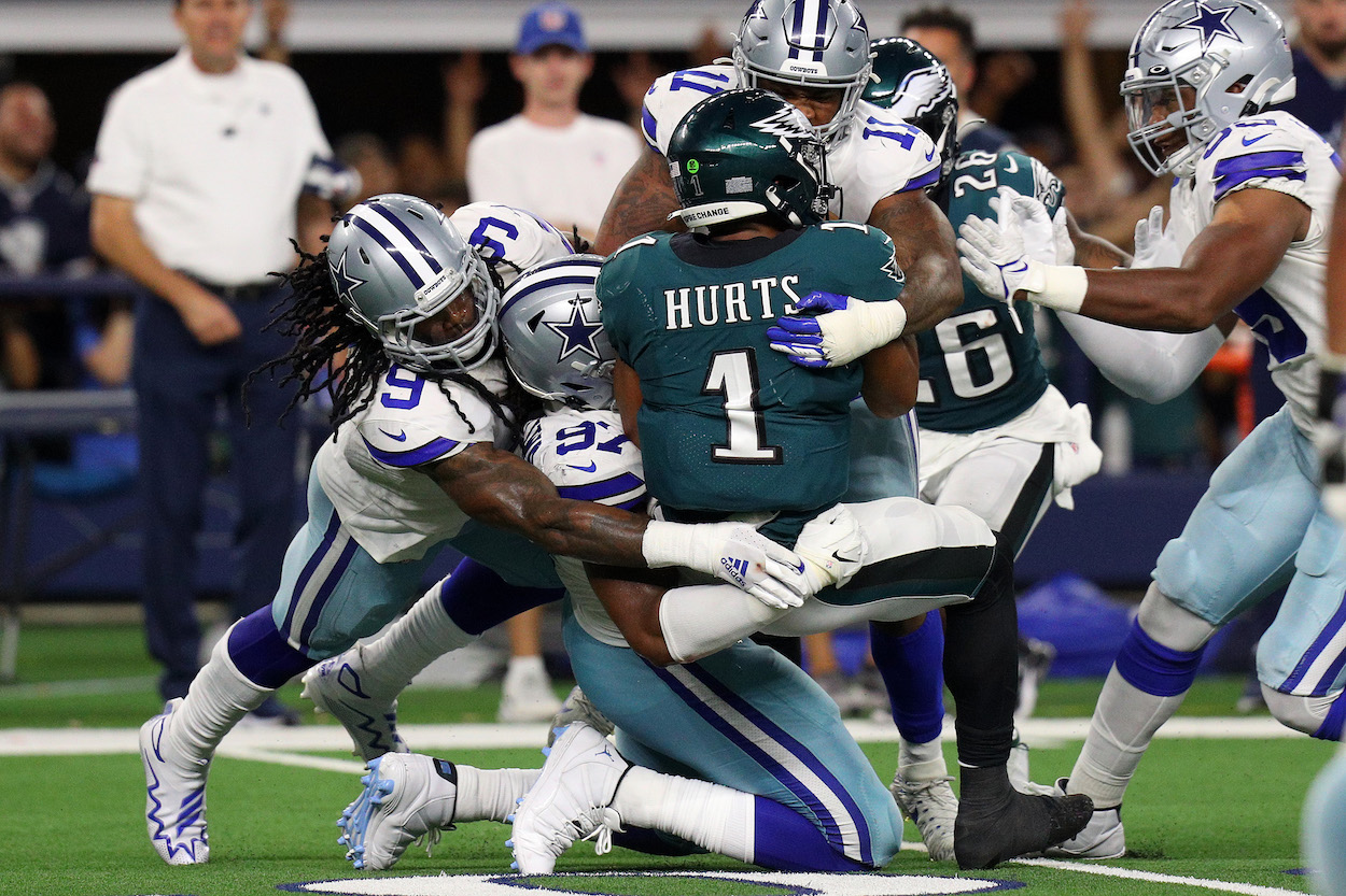 Eagles QB Jalen Hurts gets sacked by Cowboys defenders.