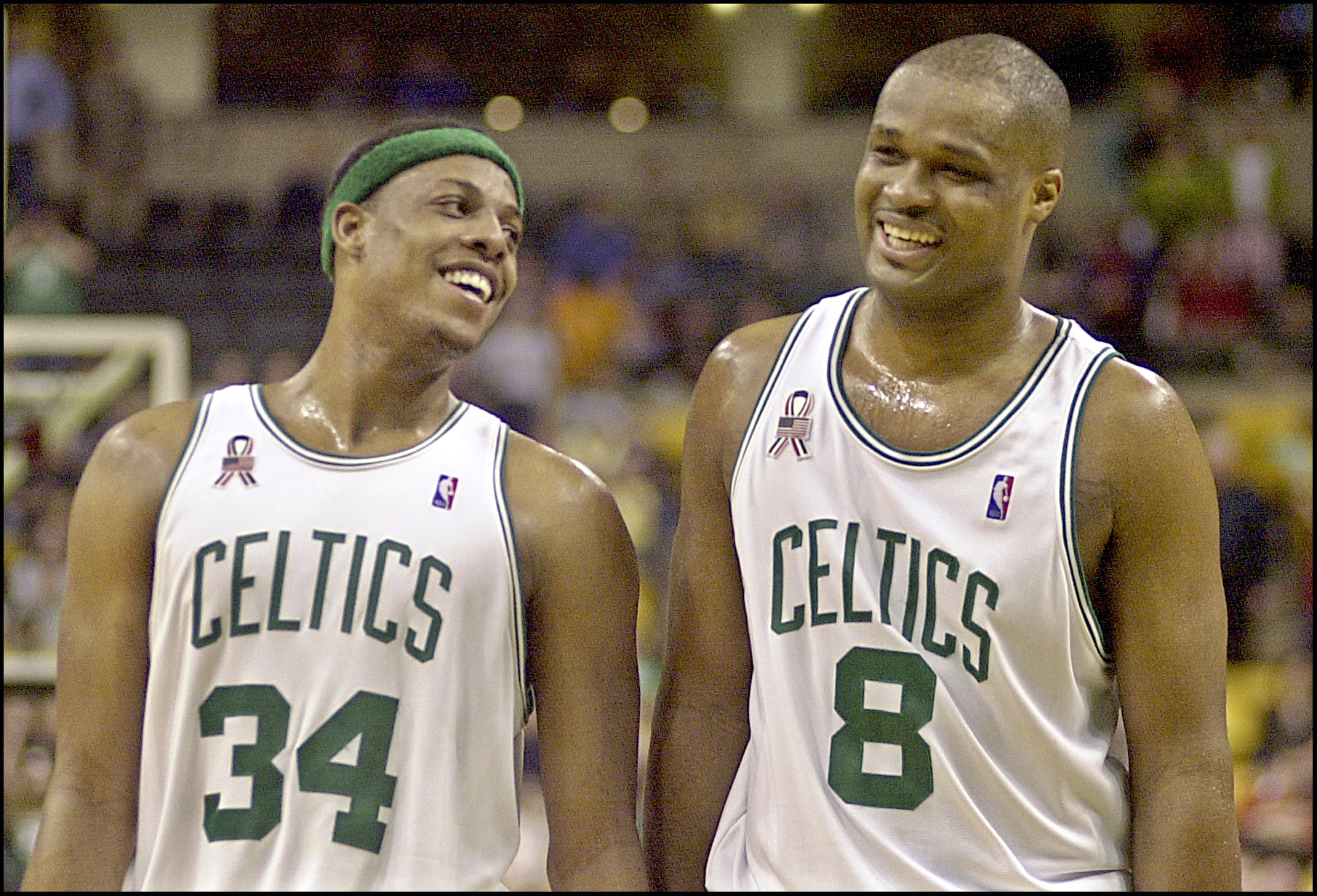 Former Celtics teammates Paul Pierce and Antonio Walker smile during a game in 2002