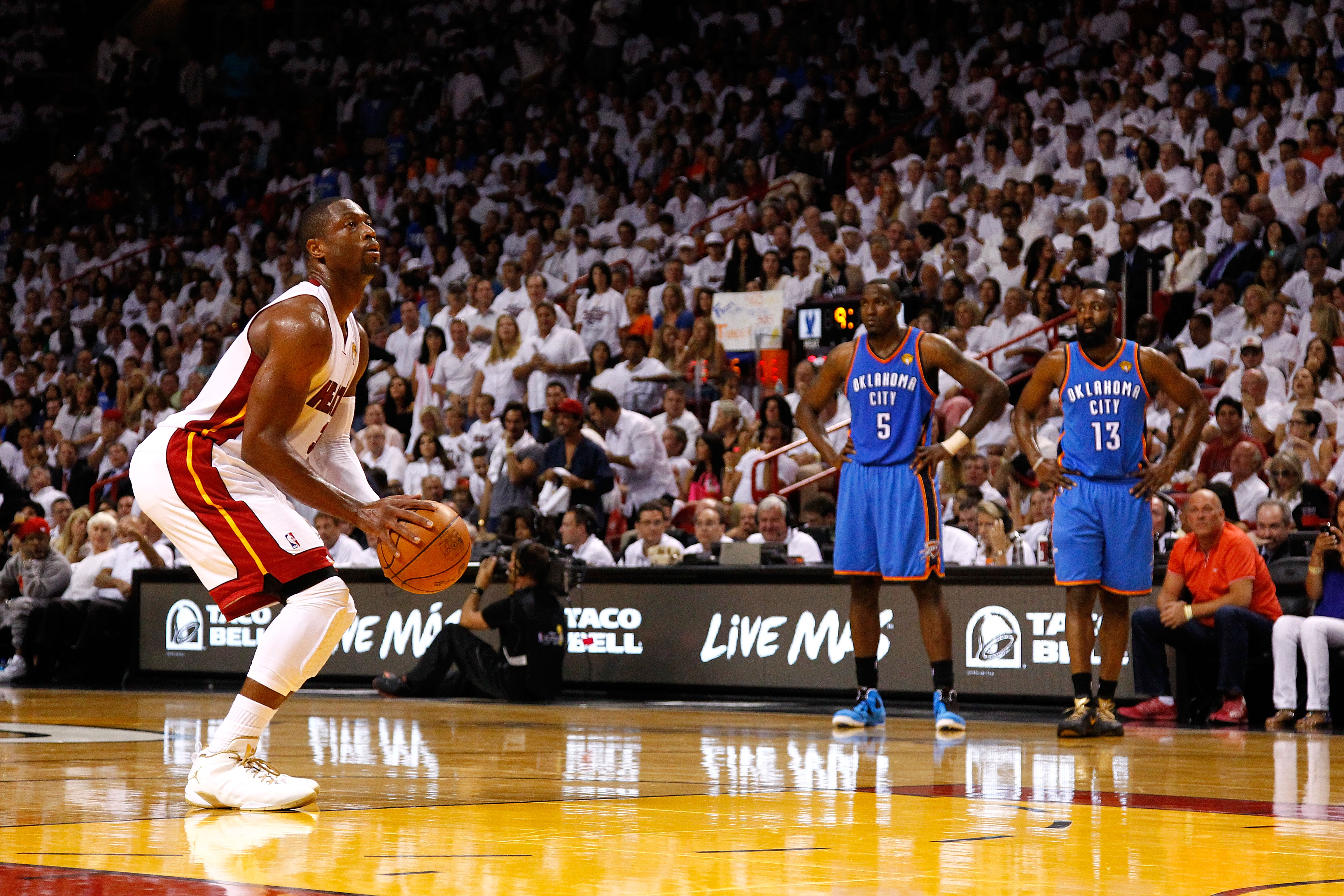 Former Thunder teammates James Harden and Kendrick Perkins watch Dwyane Wade shoot a free throw during the 2012 NBA Finals