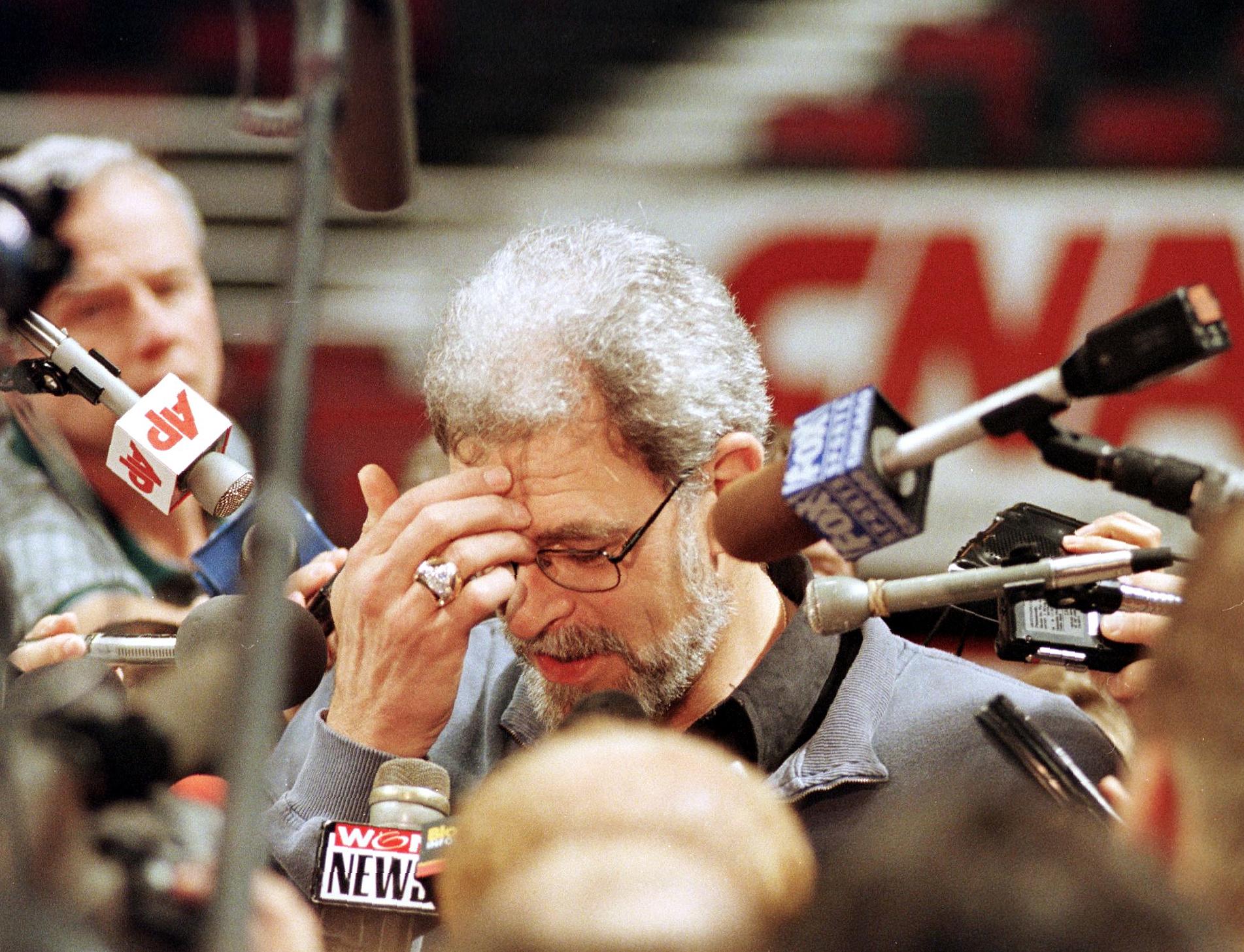 Chicago Bulls head coach Phil Jackson is surrounded by reporters.