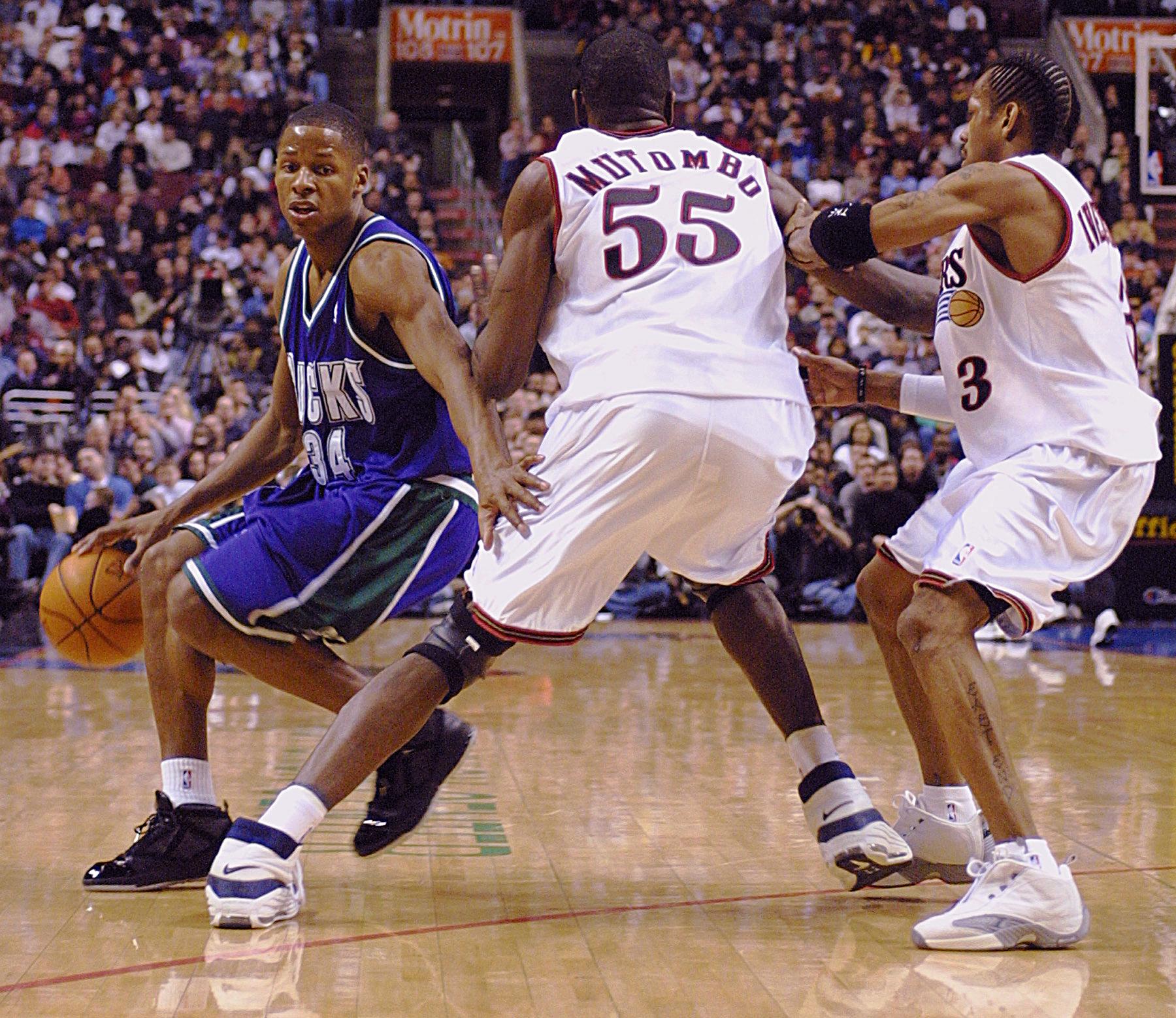Former Bucks star Ray Allen drives around then-Sixers center Dikembe Mutombo and Allen Iverson in 2001