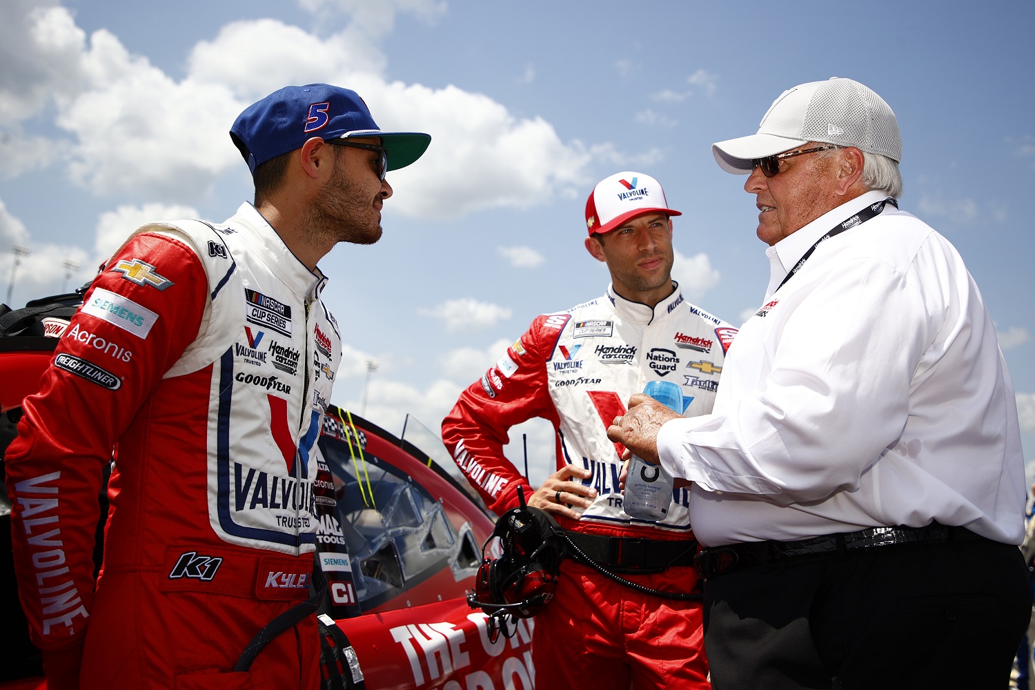 Kyle Larson, driver of the No. 5 Chevrolet, crew chief Cliff Daniels, and NASCAR Hall of Famer and team owner Rick Hendrick talk before the NASCAR Cup Series Ally 400 at Nashville Superspeedway on June 20, 2021. | Jared C. Tilton/Getty Images