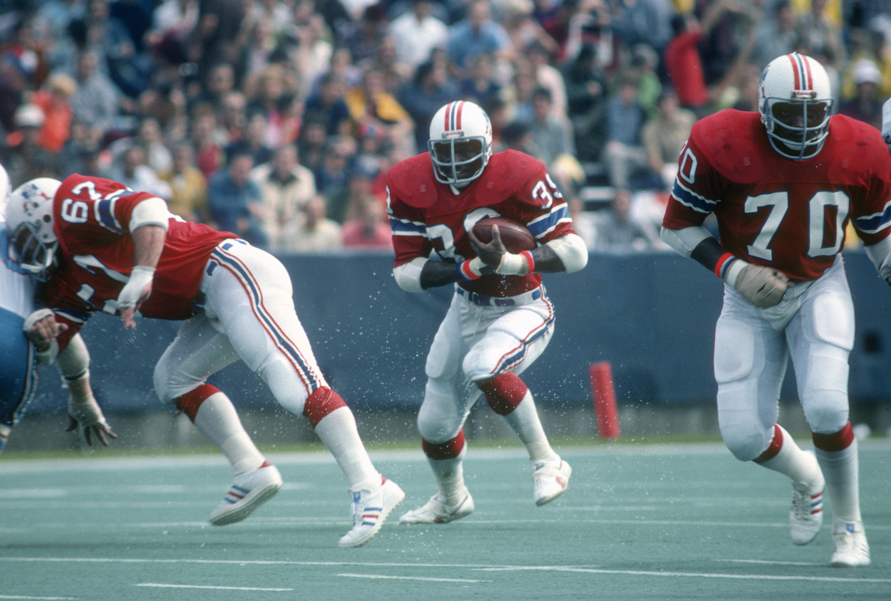 Running back Sam Cunningham of the New England Patriots carries the ball against the Houston Oilers.