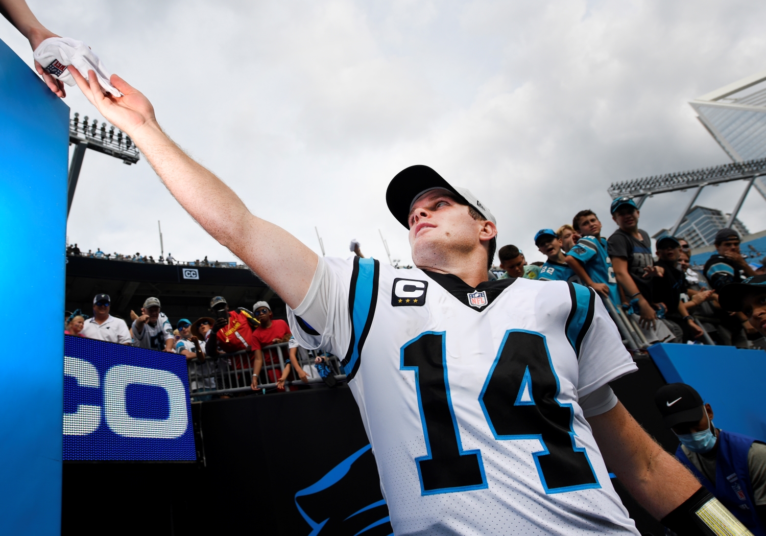 Quarterback Sam Darnold of the Carolina Panthers reaches out to a fan before the game against the New Orleans Saints.