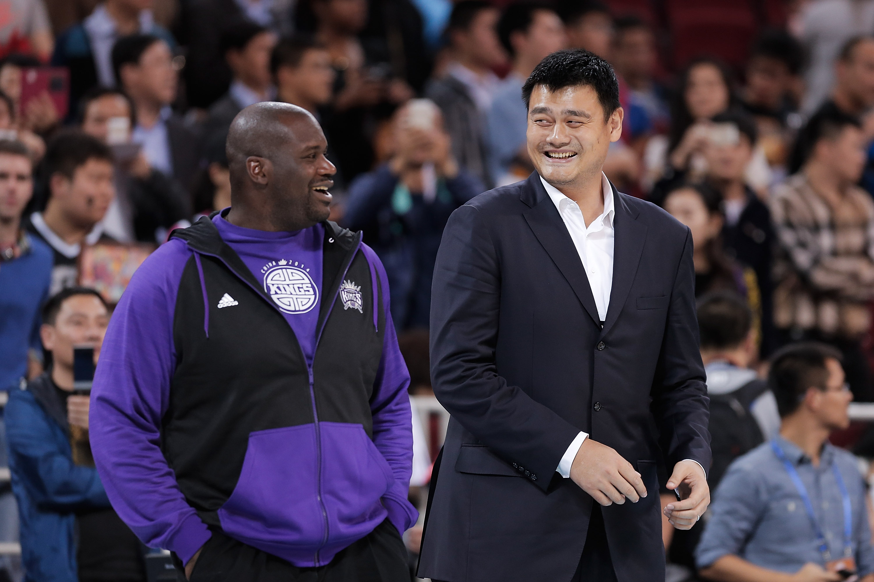 Shaquille O'Neal and Yao Ming converse during an NBA exhibition in China in 2014