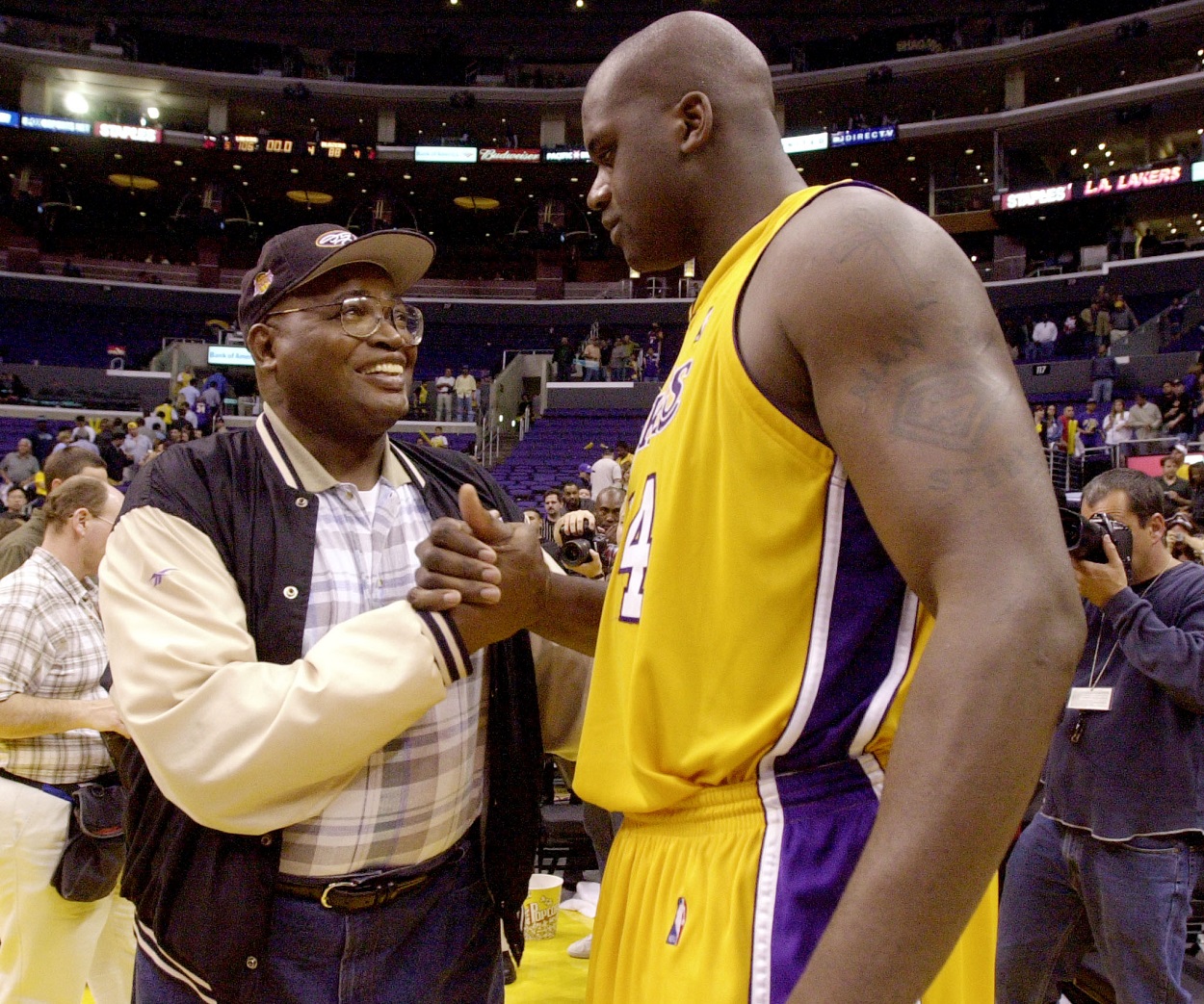 Former Lakers center Shaquille O'Neal embraces his stepdad after an NBA game.