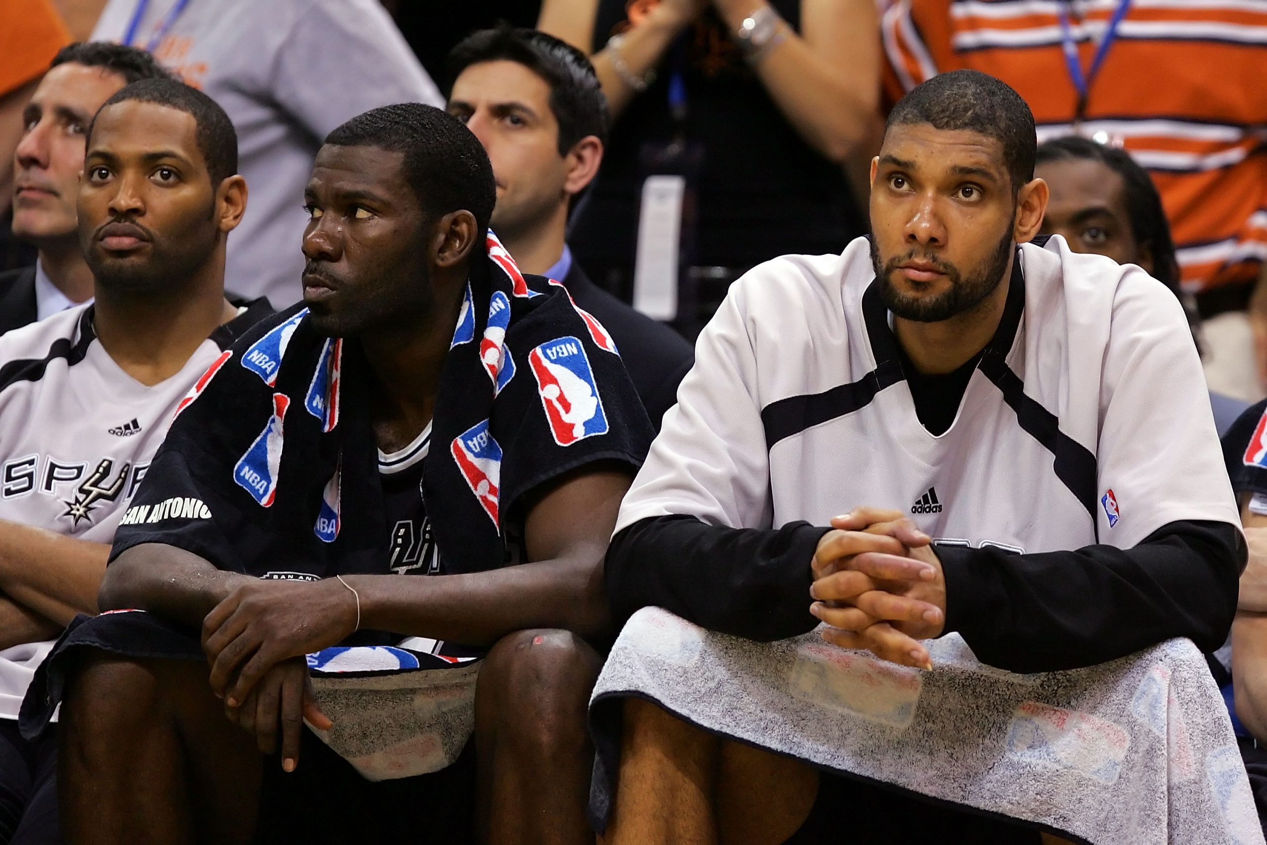 (L-R) Robert Horry , Michael Finley, and Tim Duncan of the San Antonio Spurs look on from the bench.