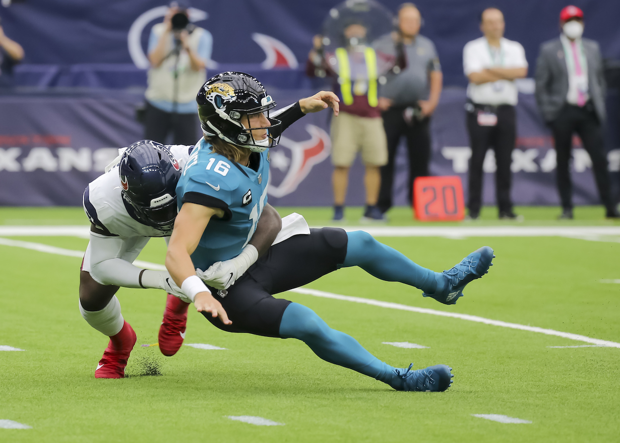 Houston Texans defensive end Charles Omenihu tackles Jacksonville Jaguars quarterback Trevor Lawrence in the fourth quarter during the football game between the Jacksonville Jaguars and Houston Texans on September 12, 2021 at NRG Stadium in Houston, Texas.