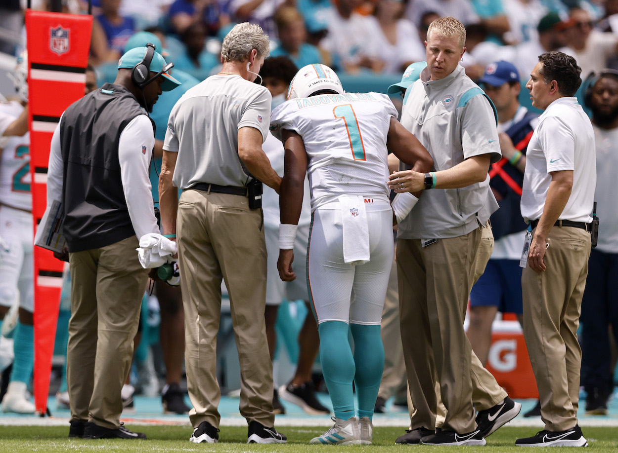 Miami Dolphins QB Tua Tagovailoa is helped off the field after a rib injury.