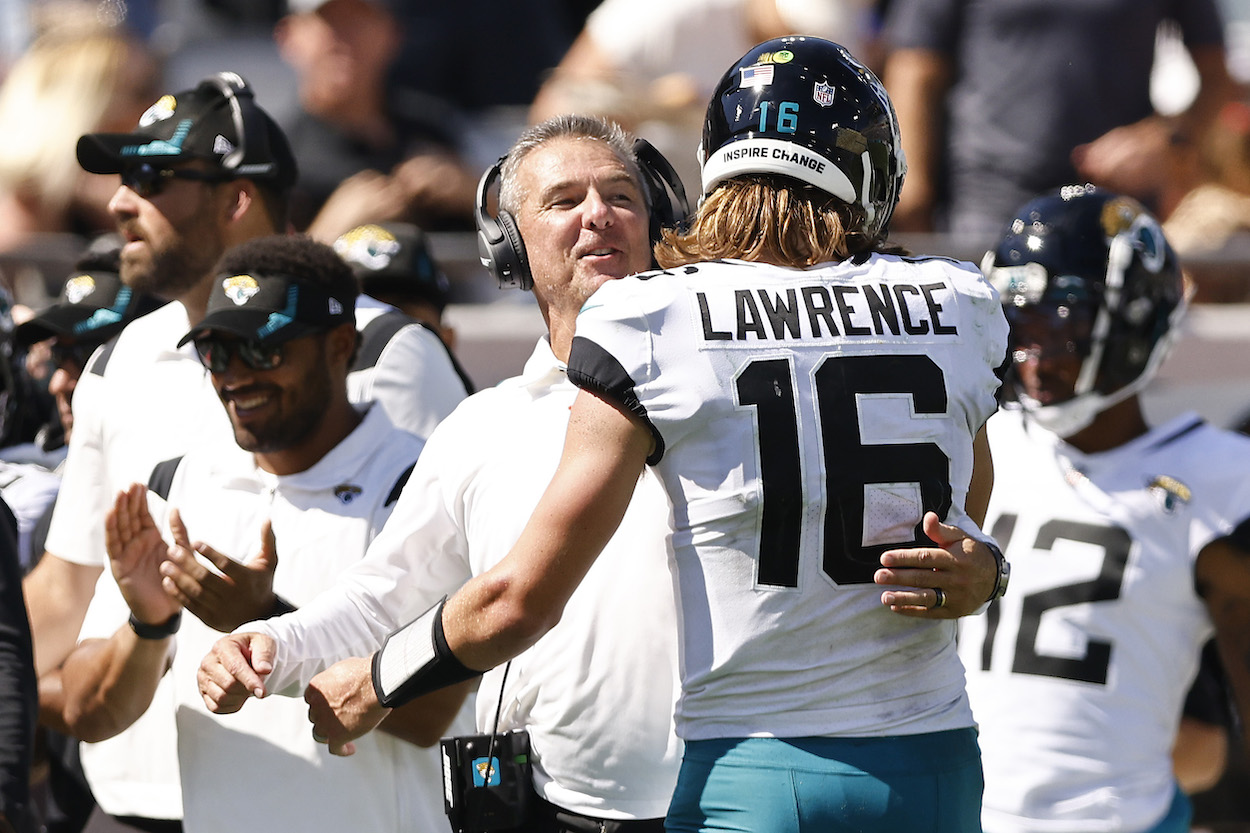 Urban Meyer and Trevor Lawrence embrace during a Jaguars game.
