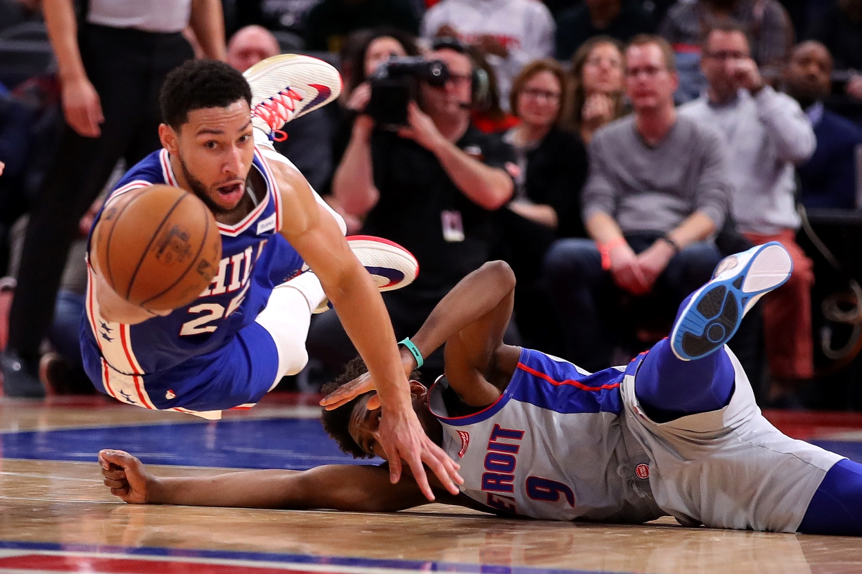 Ben Simmons of the Philadelphia 76ers dives past a Detroit Pistons defender for a loose ball.