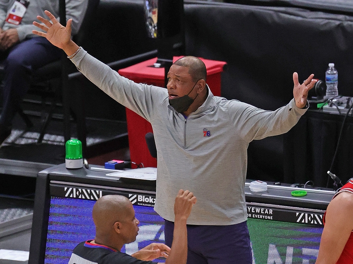 Philadelphia 76ers' head coach Doc Rivers raises his arms in frustration after a foul call.
