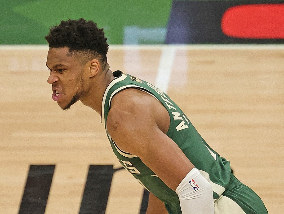 Giannis Antetokounmpo mean mugs up the floor after a dunk against the Phoenix Suns in the 2021 NBA Finals.