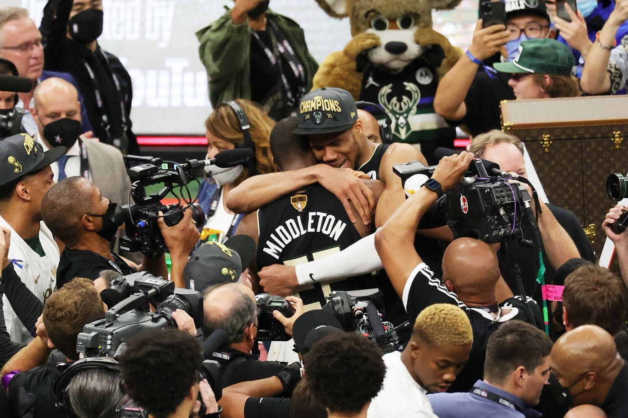 Giannis Antetokounmpo and teammate Khris Middleton embrace after the Milwaukee Bucks won the 2021 NBA Finals.