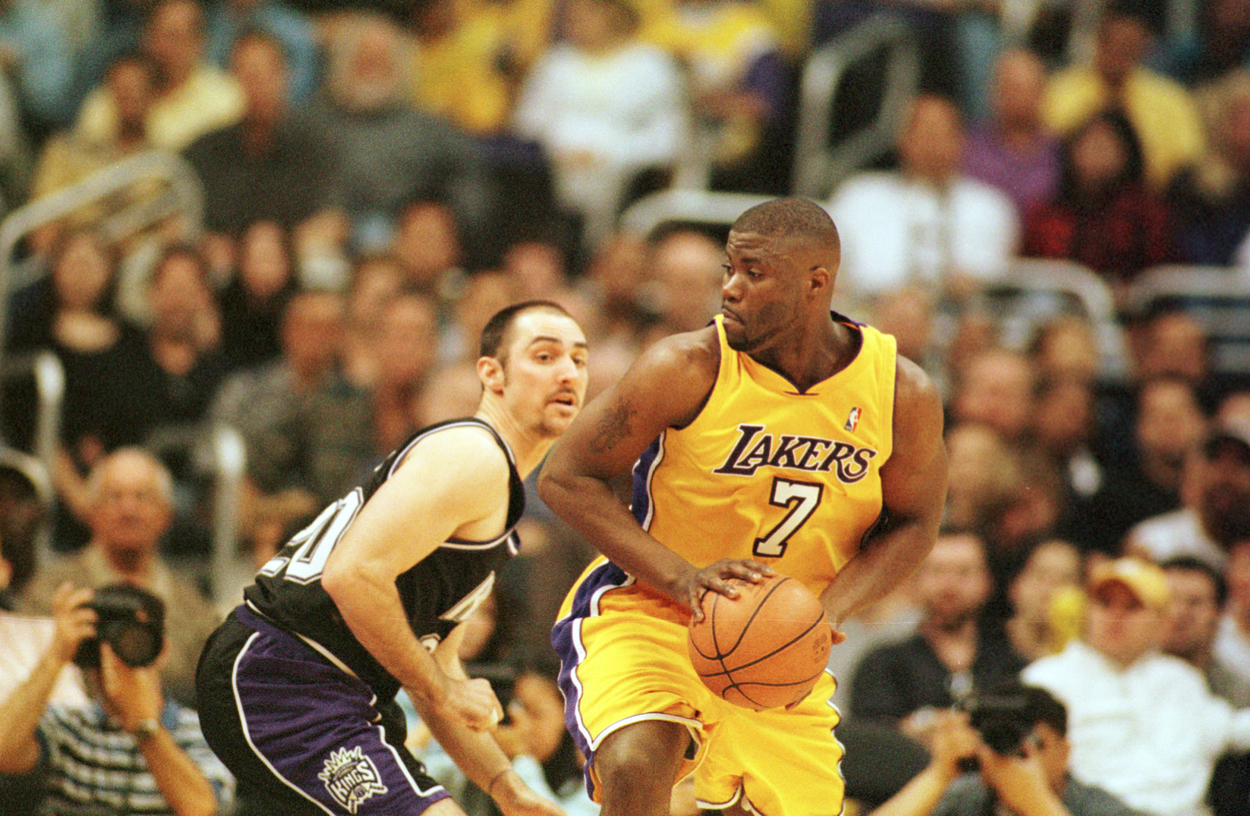 Isaiah Rider of the Los Angeles Lakers spins and looks to make a pass in a game against the Sacramento Kings.