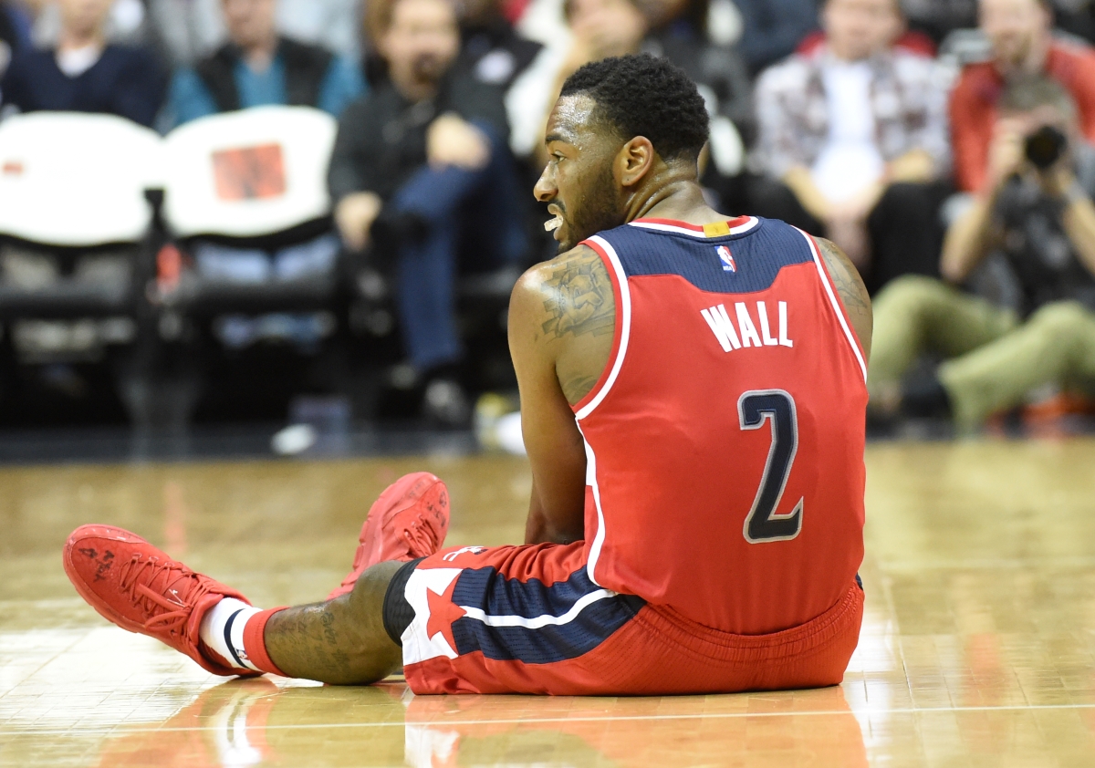 John Wall of the Washington Wizards goes down after hurting his right knee.