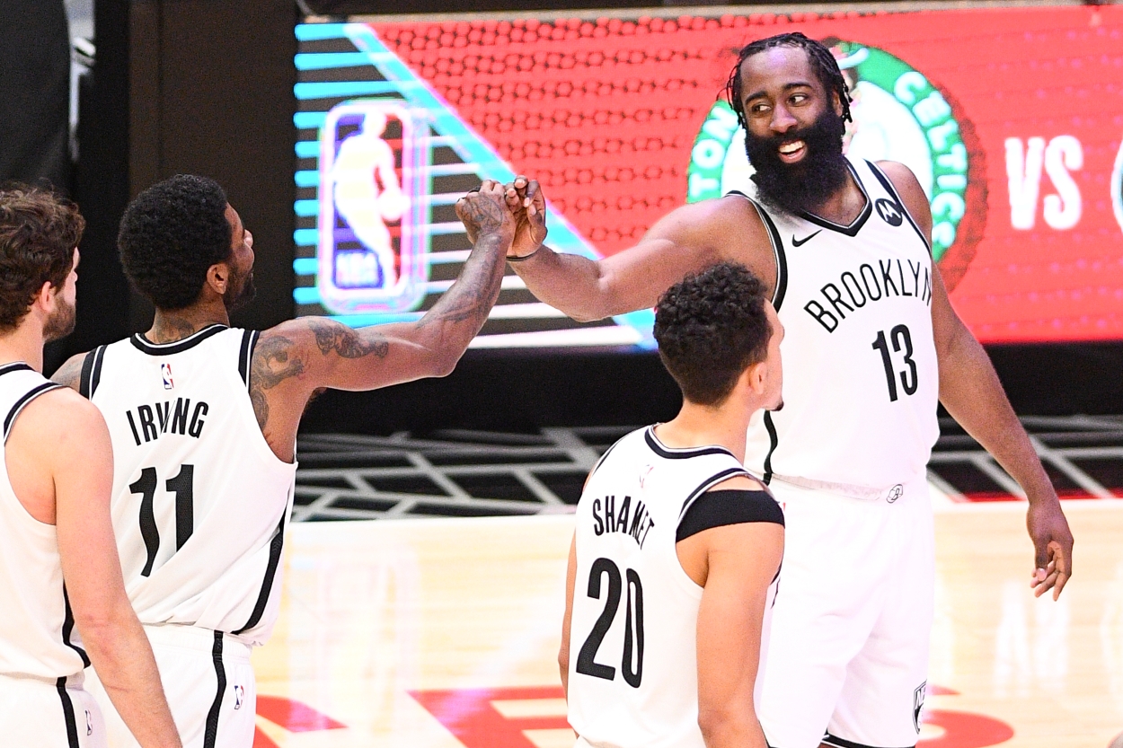 The Brooklyn Nets Kyrie Irving and James Harden give each other high fives.