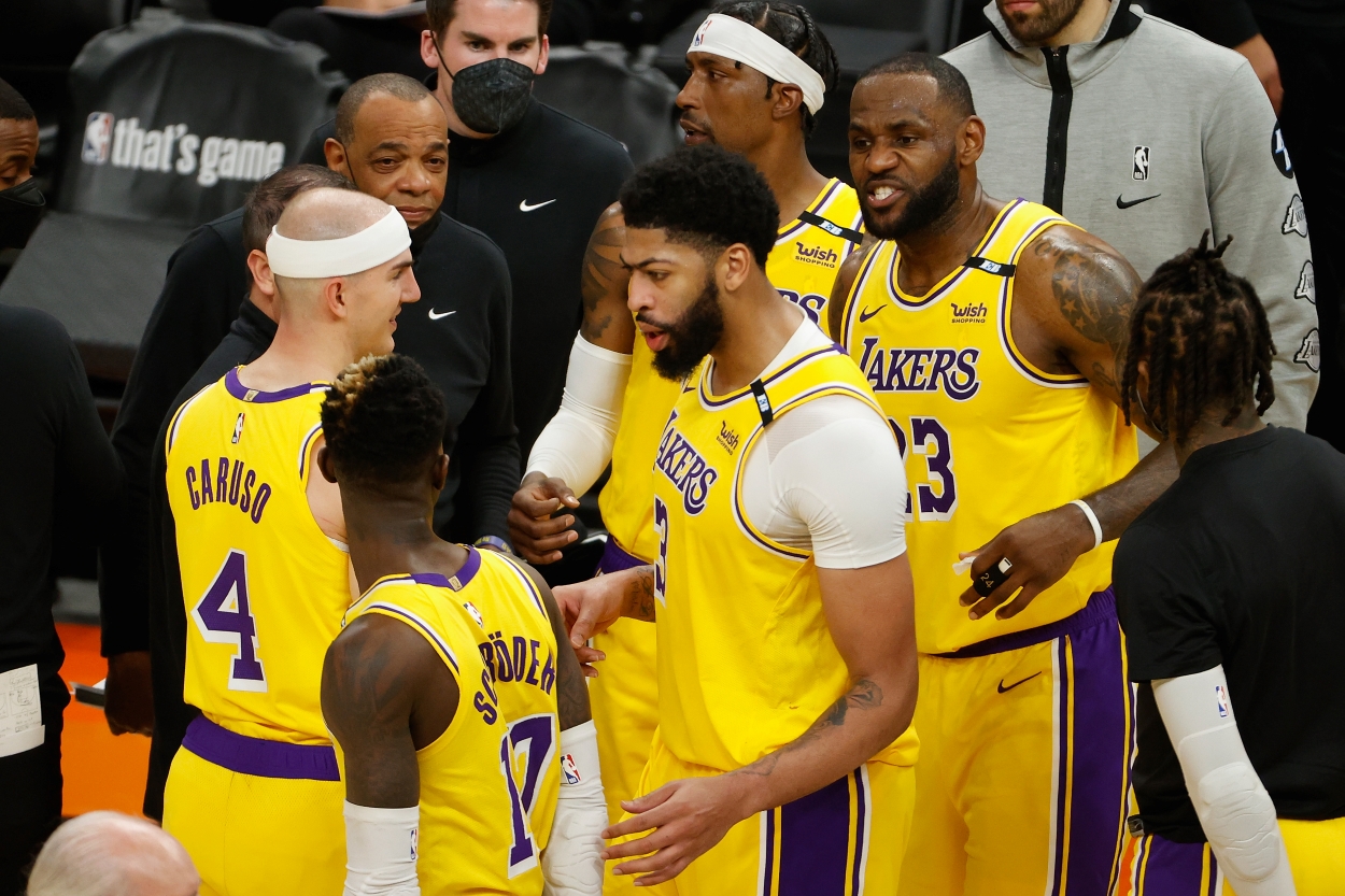 LeBron James talks with his Los Angeles Lakers teammates in a huddle.
