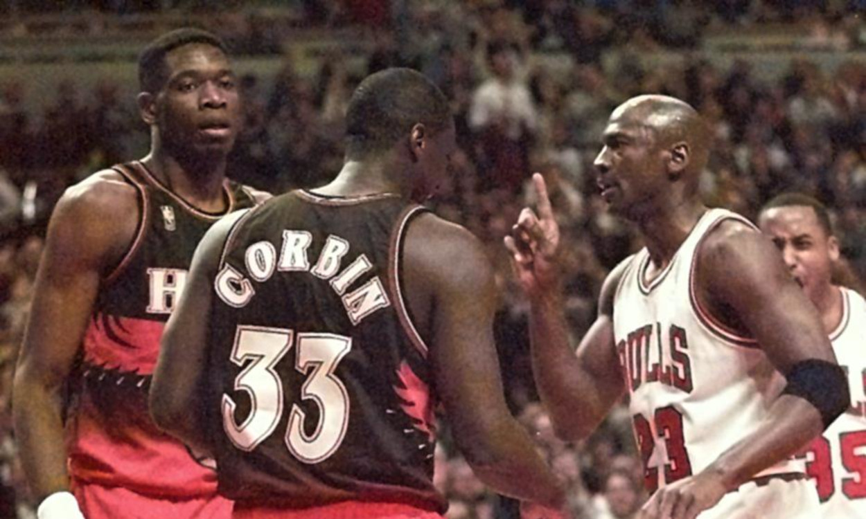 Michael Jordan waves his finger at Dikembe Mutombo after finally dunking on the big man