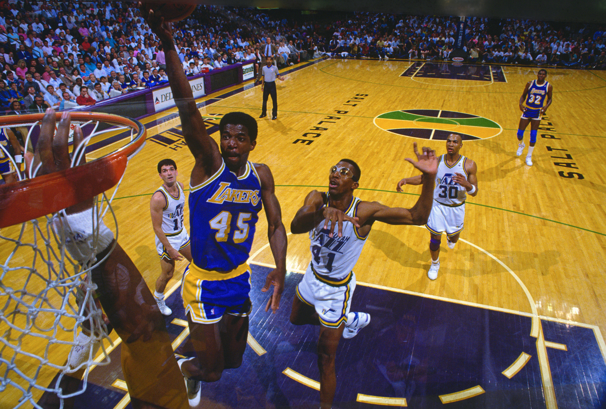 A.C. Green of the Los Angeles Lakers goes in for a layup in front of Thurl Bailey of the Utah Jazz.