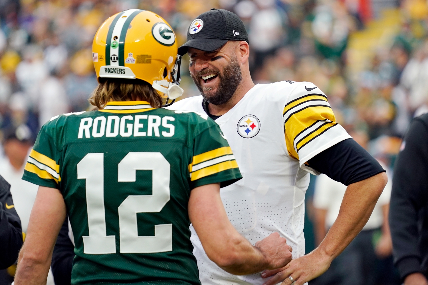 Green Bay Packers quarterback Aaron Rodgers speaks to Pittsburgh Steelers quarterback Ben Roethlisberger before a game.