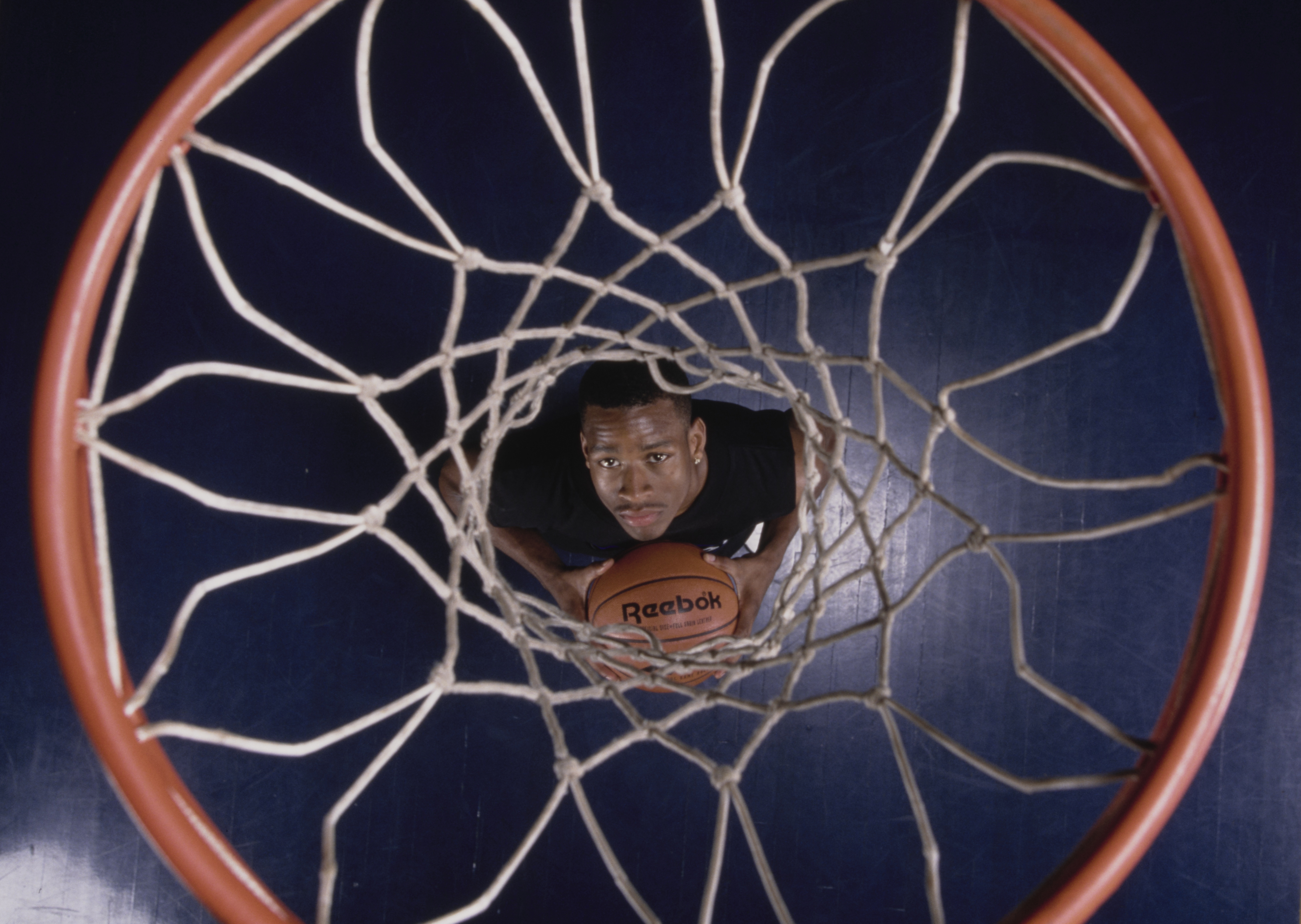 Philadelphia 76ers legend Allen Iverson poses underneath the basket in 1996