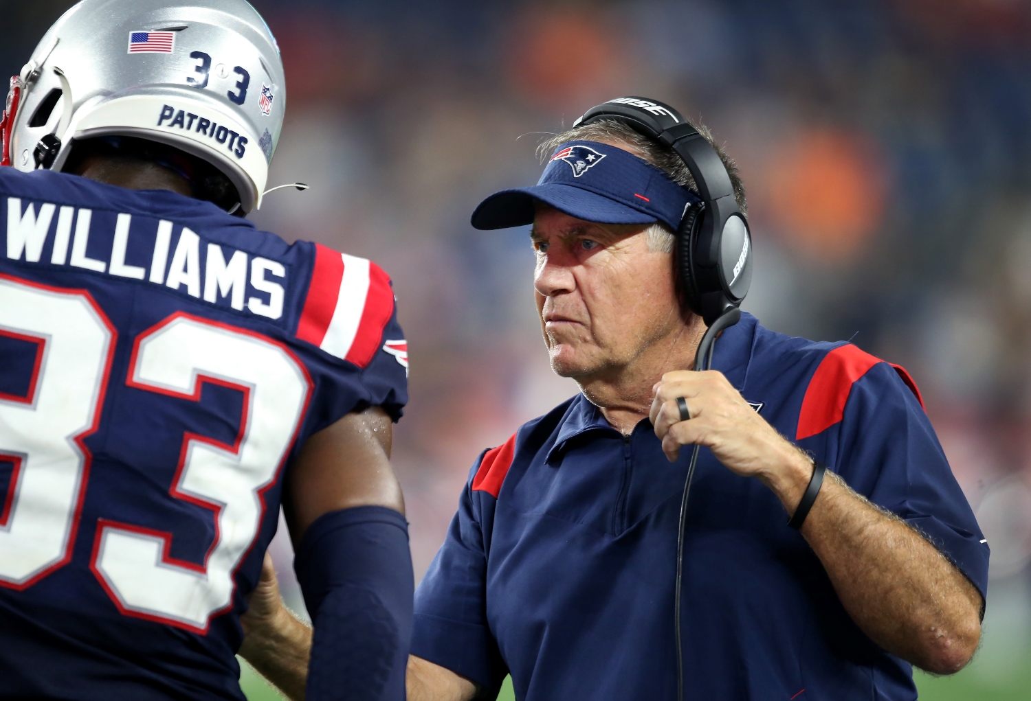 New England Patriots head coach Bill Belichick is on the sidelines with cornerback Joejuan Williams.