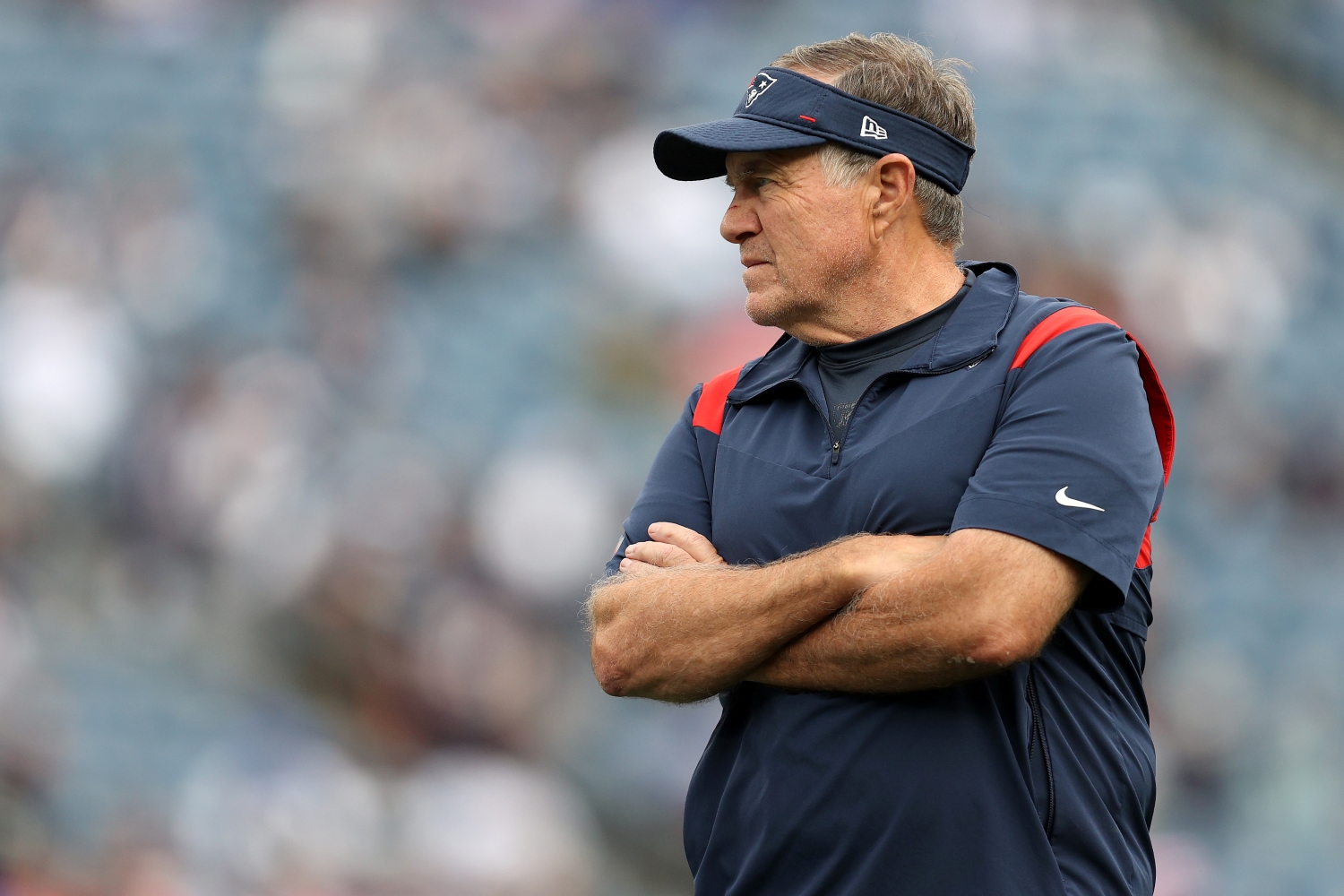 New England Patriots head coach Bill Belichick stands on the field before a game against the Dallas Cowboys.