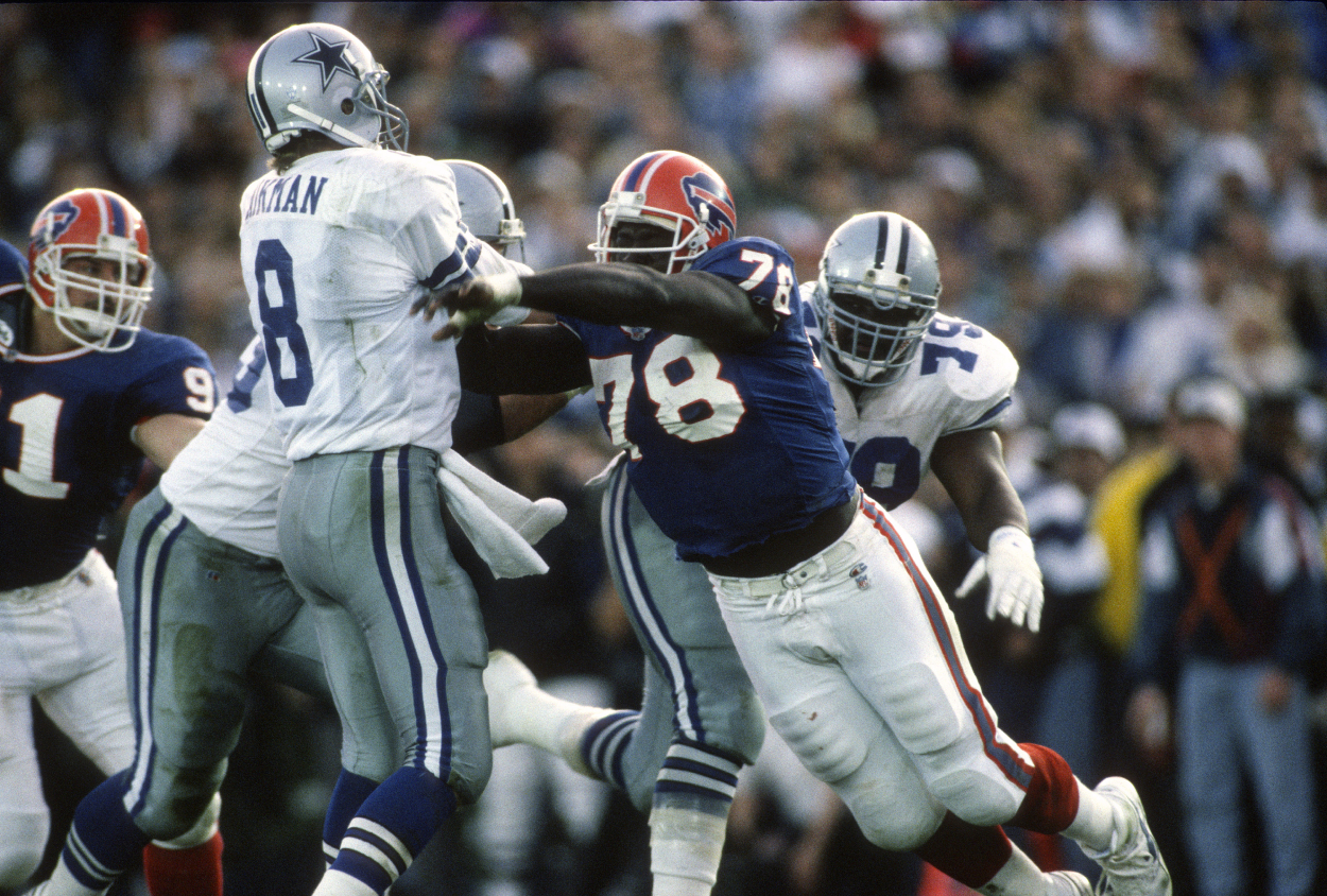 Troy Aikman of the Dallas Cowboys gets his pass off under pressure from Bruce Smith of the Buffalo Bills.