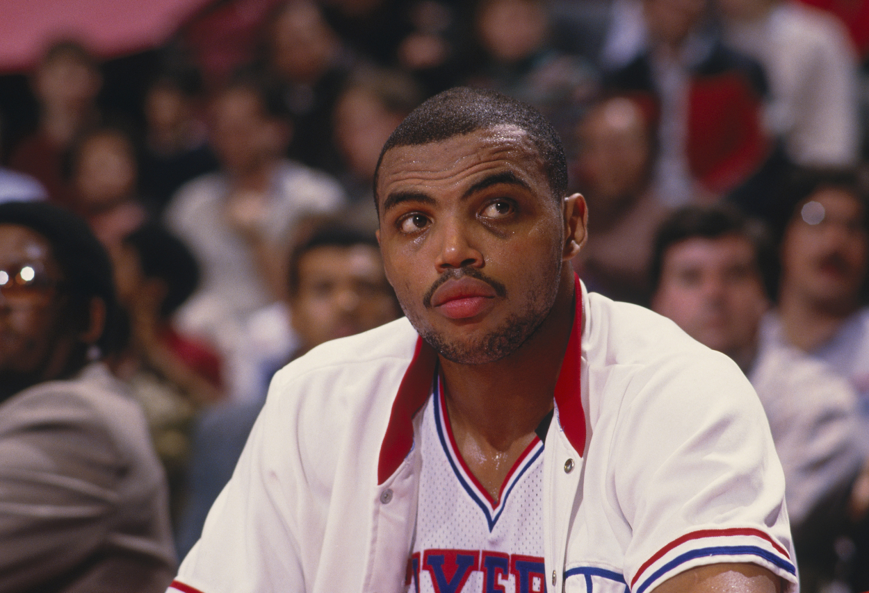 Philadelphia 76ers player Charles Barkley watches the game from the bench.