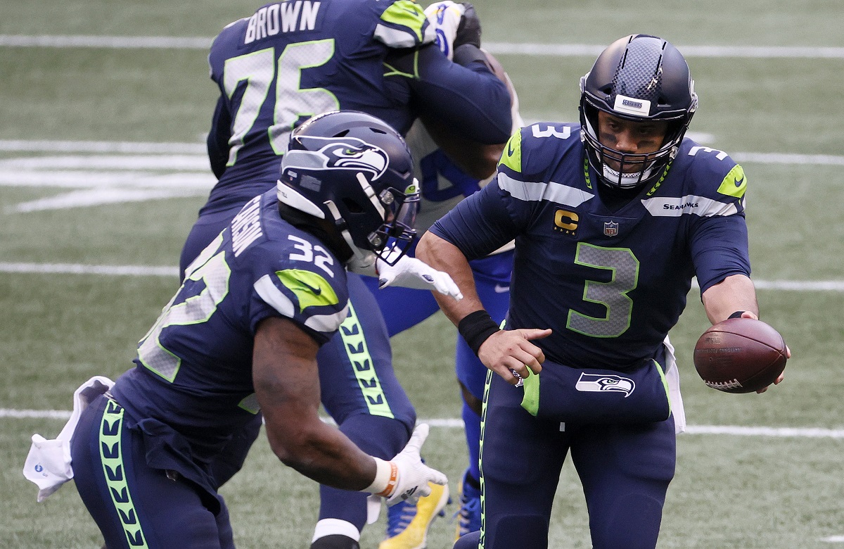 Chris Carson and Russell Wilson execute a play for the Seattle Seahawks