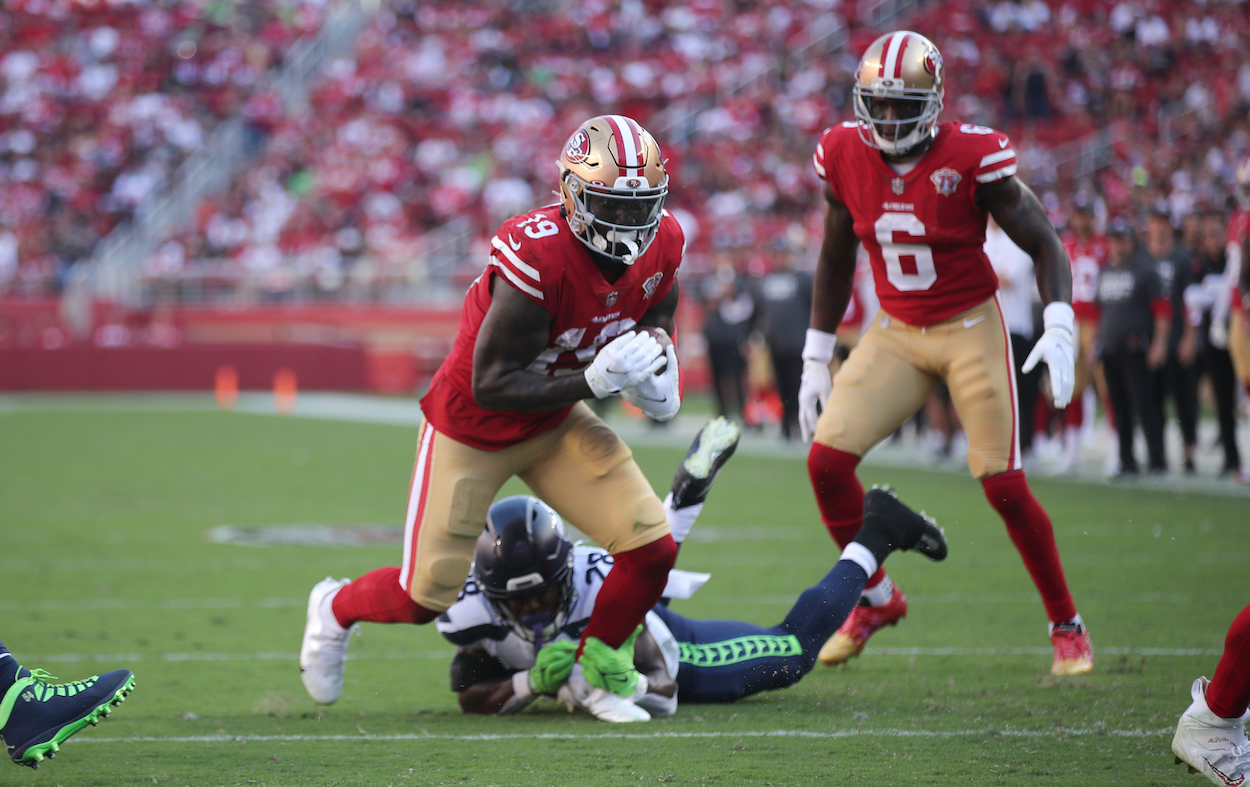 Deebo Samuel of the San Francisco 49ers heads to the end zone on an 8-yard touchdown catch during the game against the Seattle Seahawks at Levi's Stadium on October 3, 2021 in Santa Clara, California.