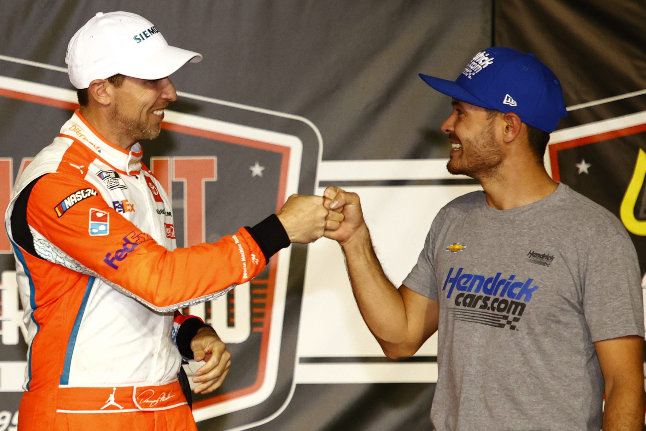 Kyle Larson, right, congratulates Denny Hamlin on victory lane after the NASCAR Cup Series Cook Out Southern 500 at Darlington Raceway on Sept. 5, 2021.
