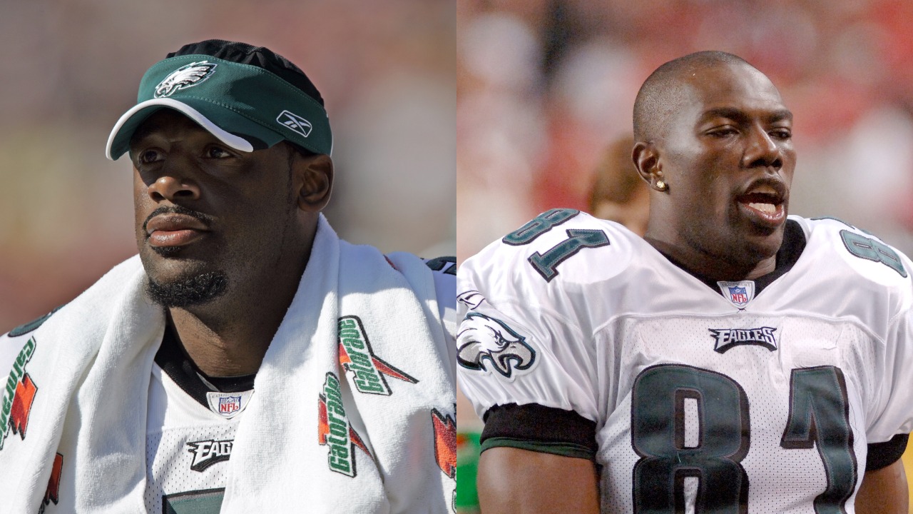 Eagles QB Donovan McNabb looks on from the sideline; Terrell Owens talking on the Eagles sideline
