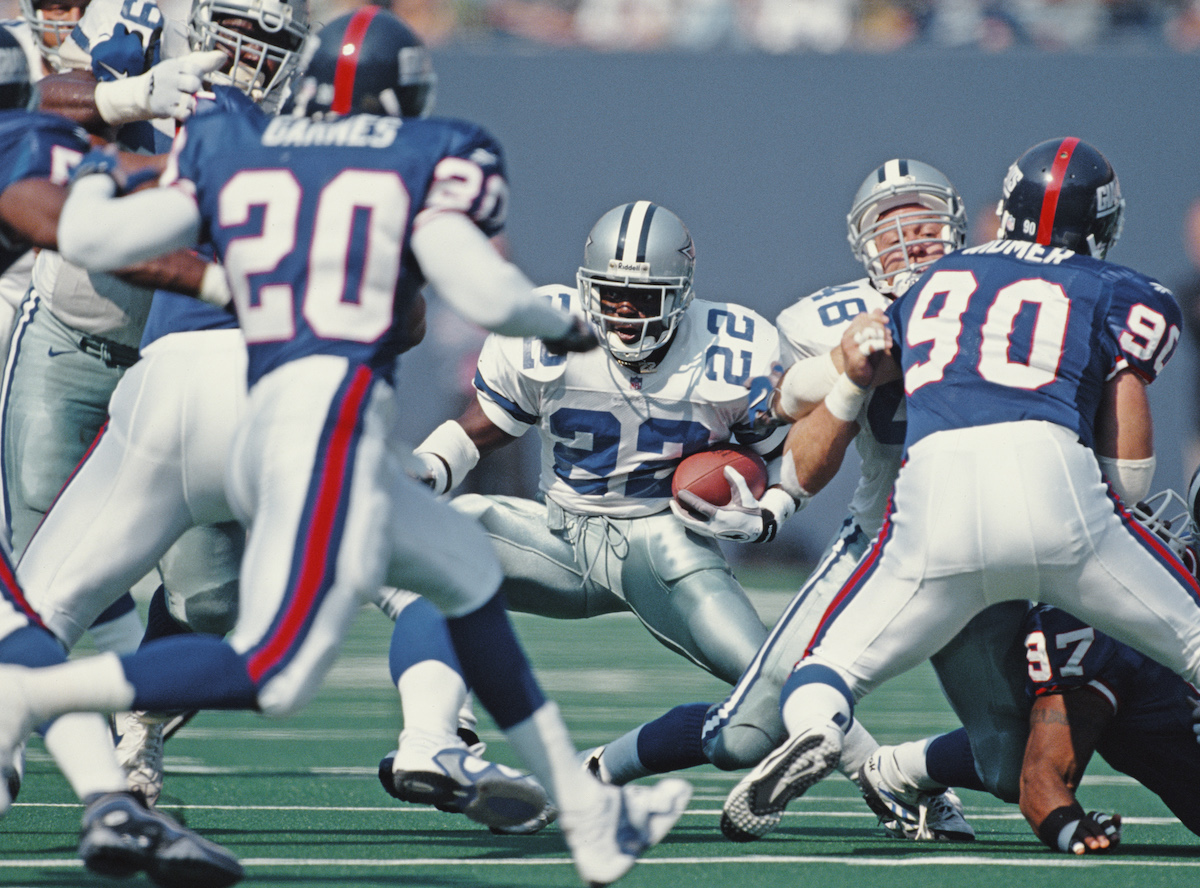 Emmitt Smith, #22, running back for the Dallas Cowboys, runs the ball through the Giants defence during the NFC East game against the New York Giants on October 5, 1997, at the Giants Stadium, East Rutherford, New Jersey