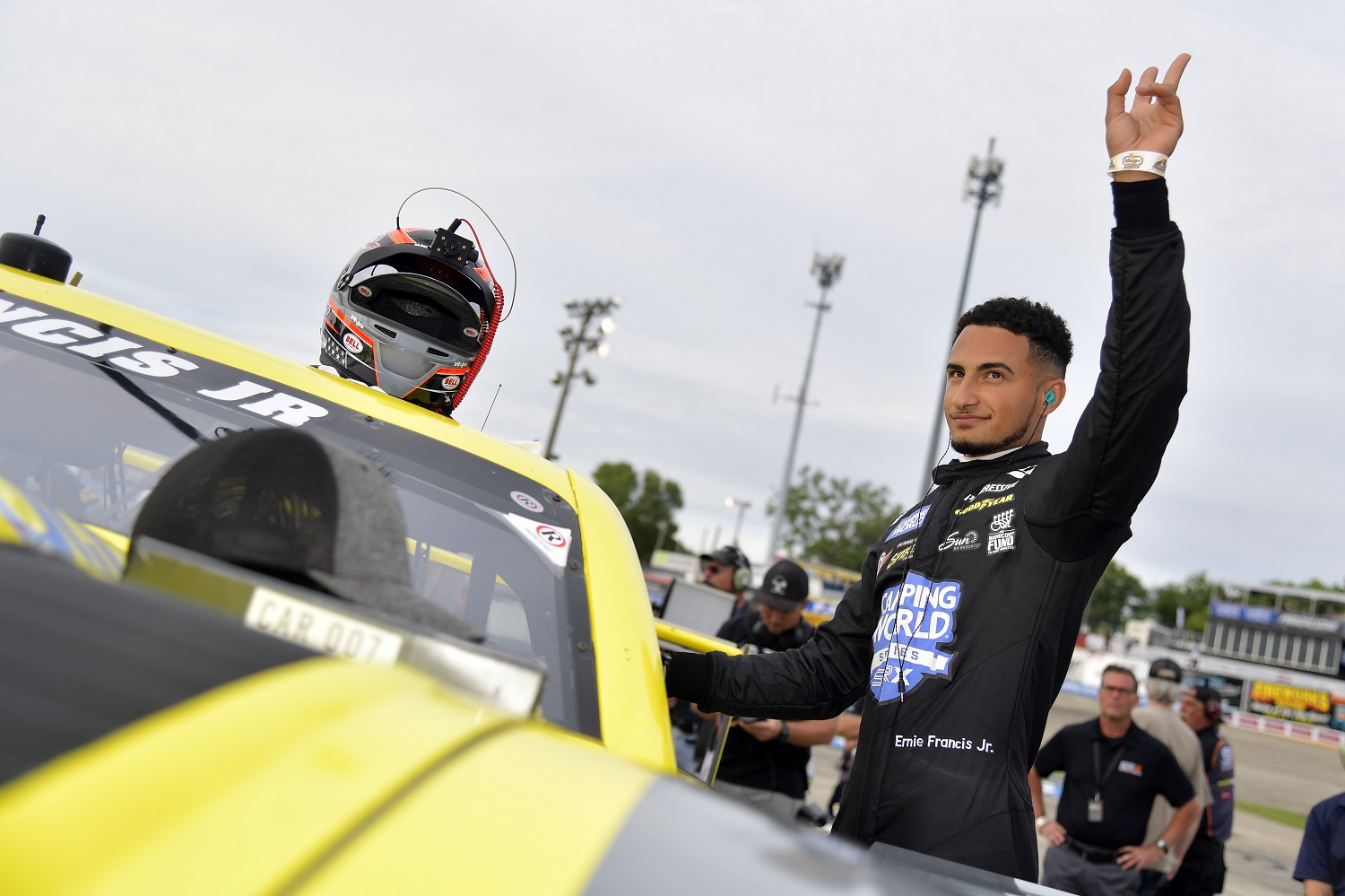 Ernie Francis Jr. waves to fans before climbing into his car during the Camping World Superstar Racing Experience (SRX) event at Slinger Speedway on July 10, 2021, in Slinger, Wisconsin.
