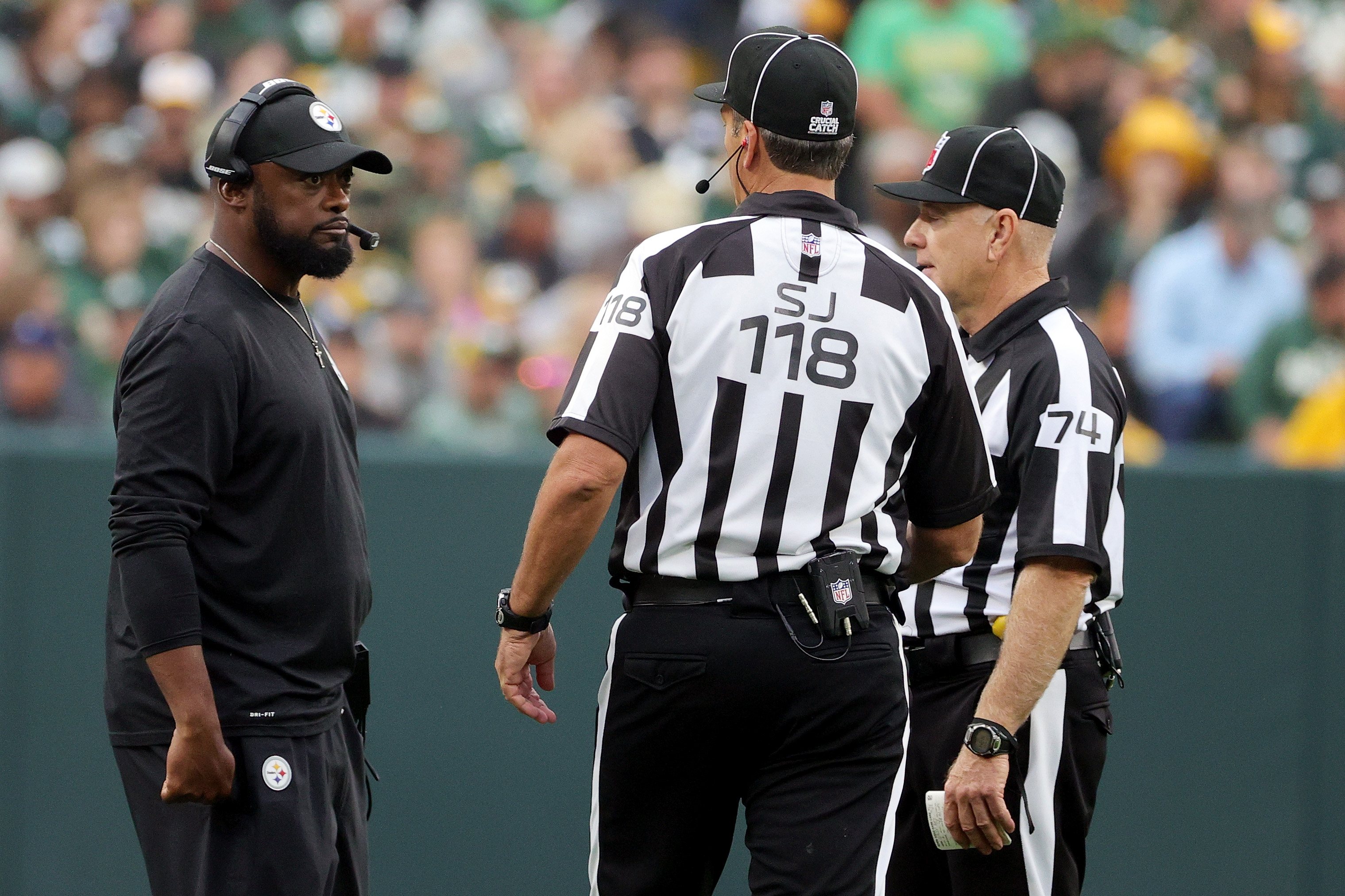 Steelers HC Mike Tomlin talking with officials.
