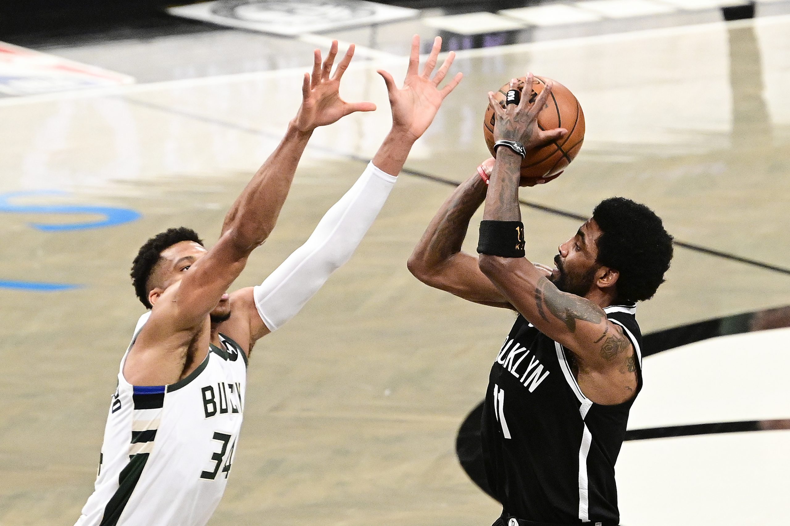 Kyrie Irving of the Brooklyn Nets attempts a shot against Giannis Antetokounmpo.