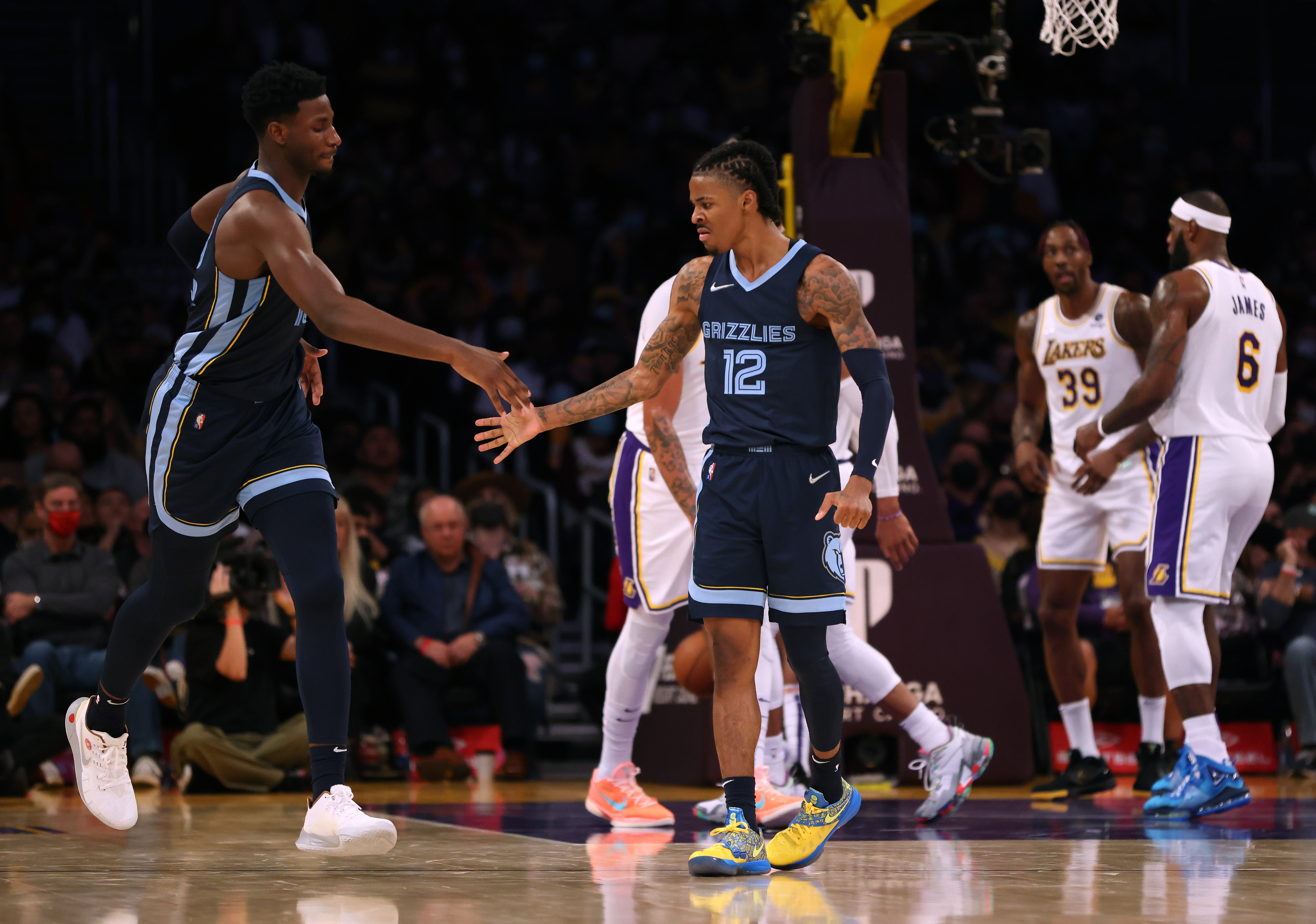 Grizzlies star Ja Morant high-fives Jaren Jackson Jr. during Sunday's game against the Lakers