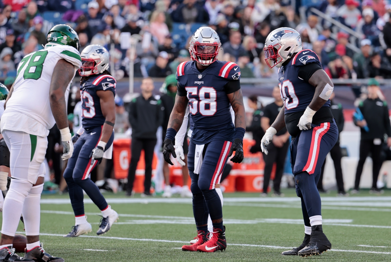 New England Patriots linebacker Jamie Collins Sr. speaks to defensive tackle Christian Barmore before a play against the New York Jets.