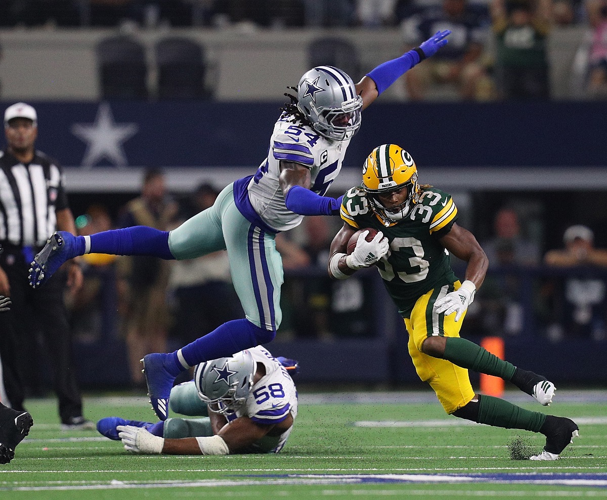 Jaylon Smith of the Dallas Cowboys tries to tackle Aaron Jones of the Green Bay Packers