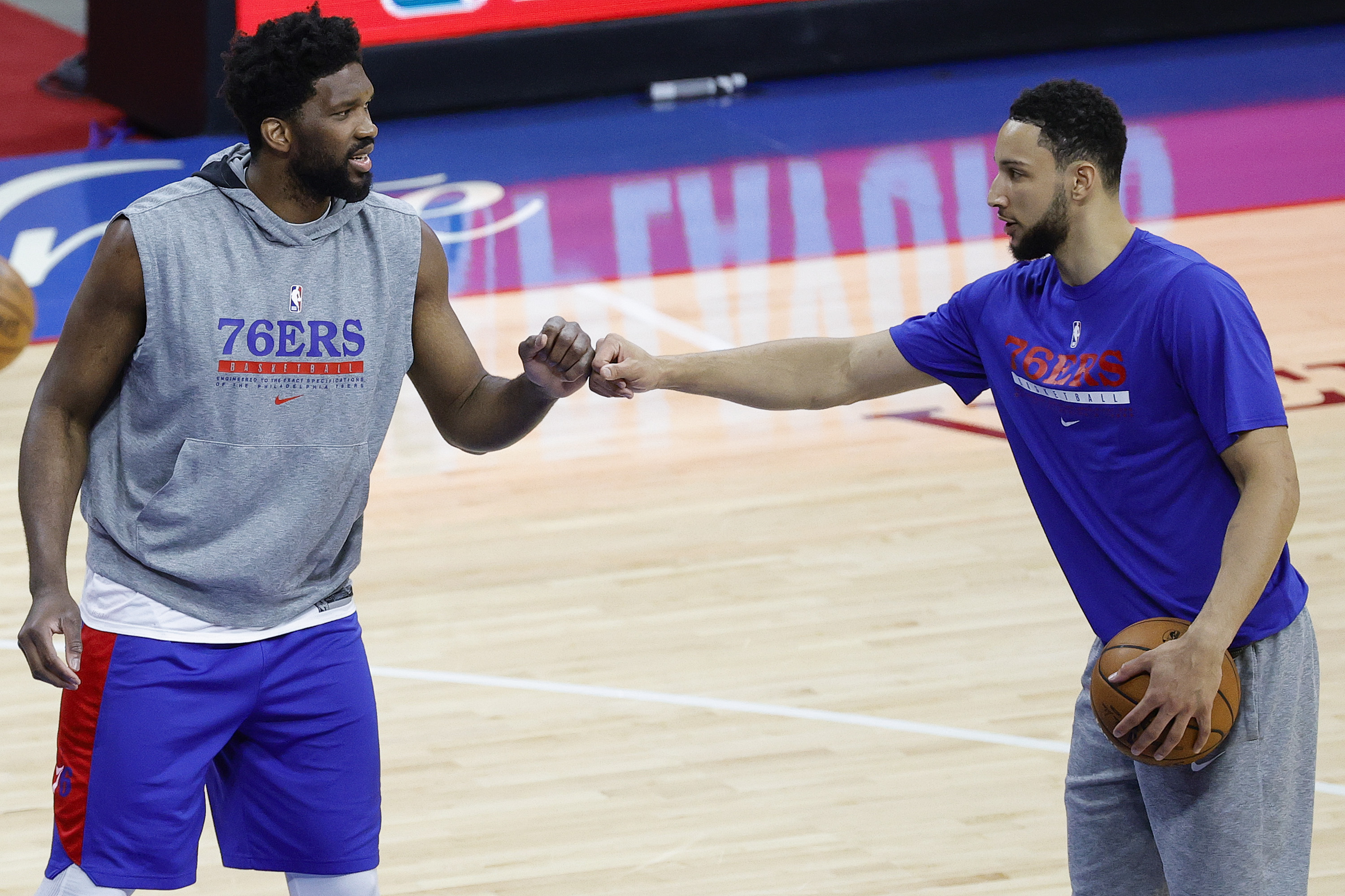 76ers stars Joel Embiid and Ben Simmons dap up before a playoff game