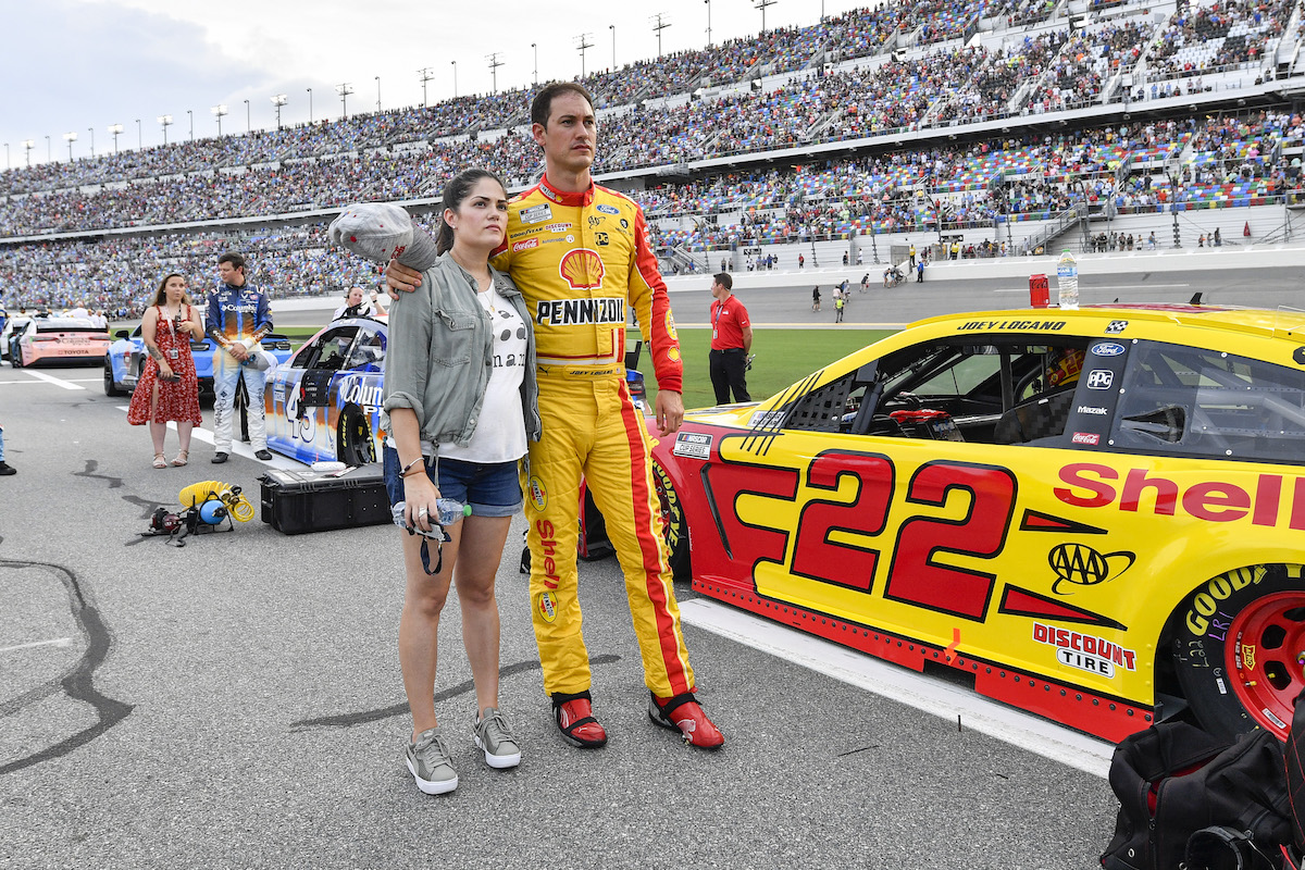 Joey Logano of car #22 stands with his wife, Brittany Baca, during the National Anthem before the Coke Zero Sugar 400 on August 28, 2021, at Daytona International Speedway