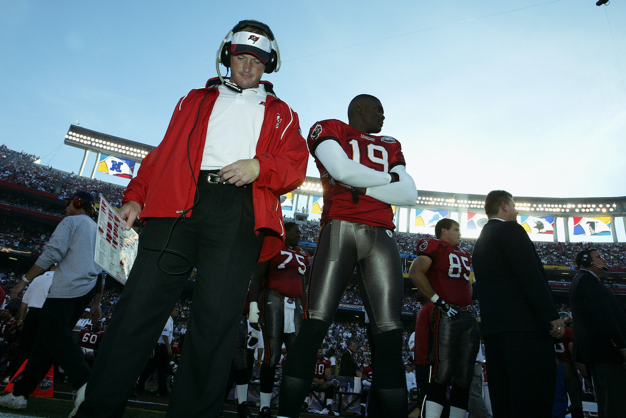 Head coach Jon Gruden and wide receiver Keyshawn Johnson of the Tampa Bay Buccaneers stand on the field before the start of Super Bowl XXXVII against the Oakland Raiders at Qualcomm Stadium on January 26, 2003 in San Diego, California.