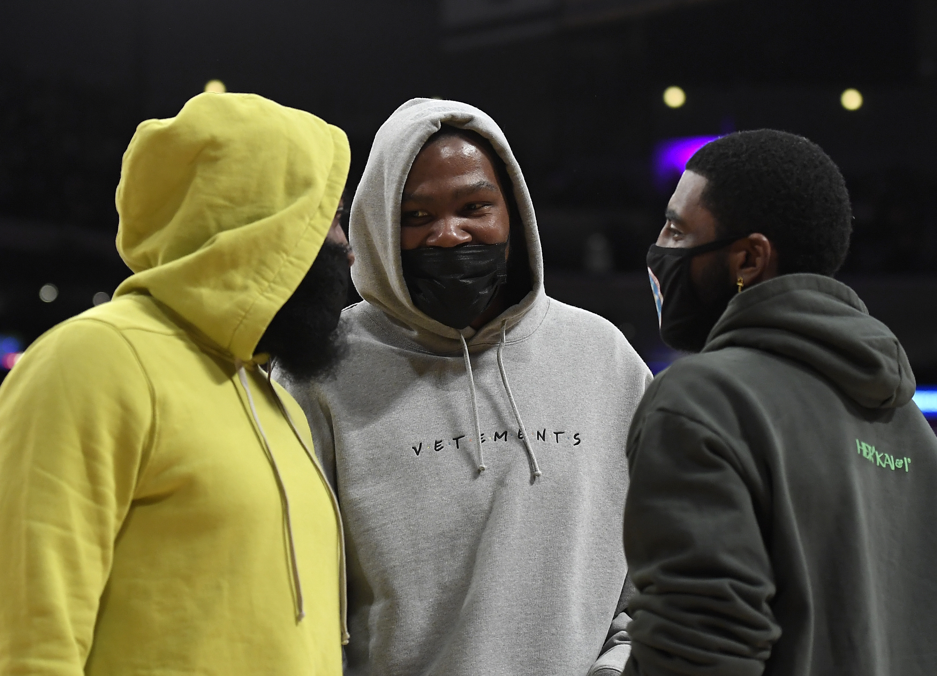 (L-R): Nets stars James Harden, Kevin Durant and Kyrie Irving talk ahead of a preseason game against the Los Angeles Lakers