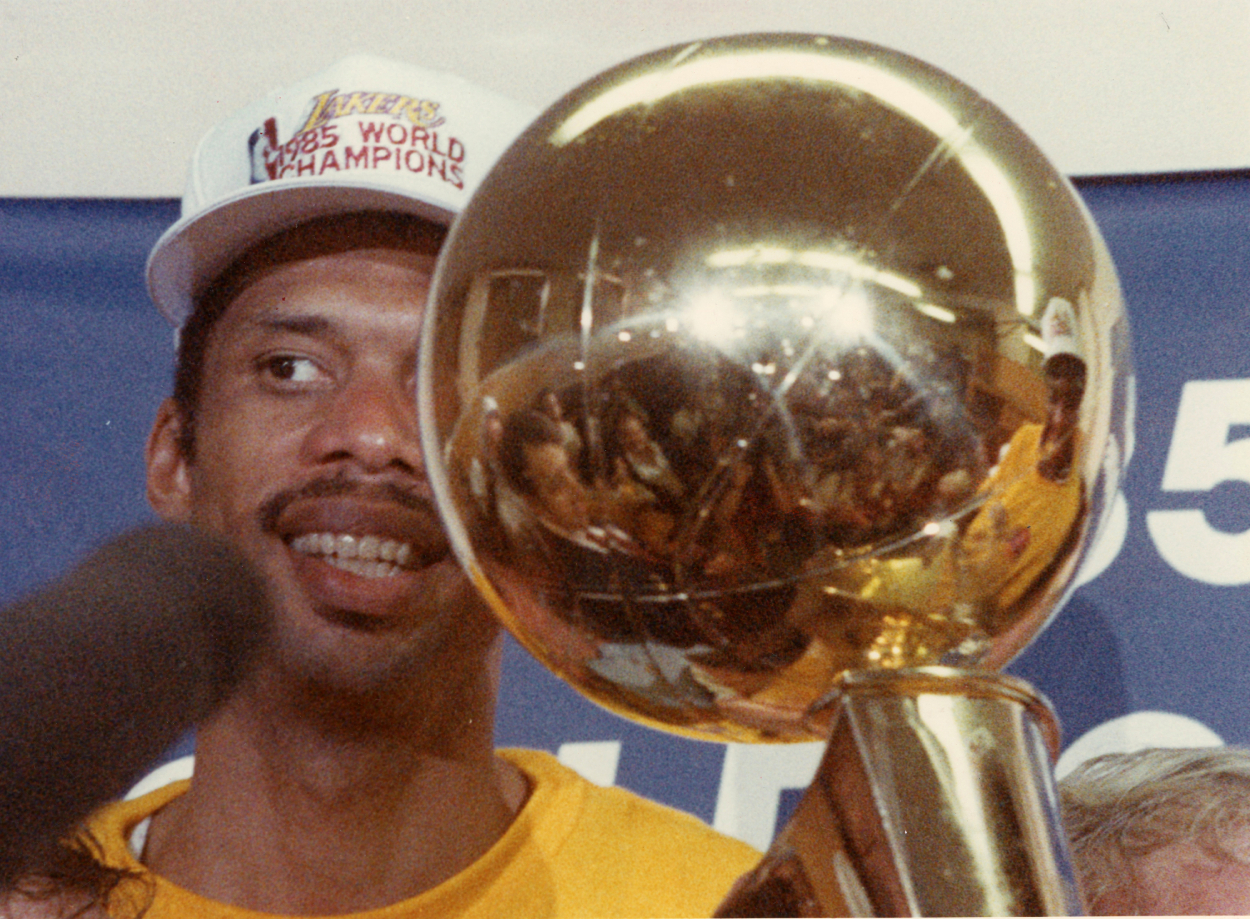 Los Angeles Lakers Kareem Abdul-Jabbar holds the championship trophy.
