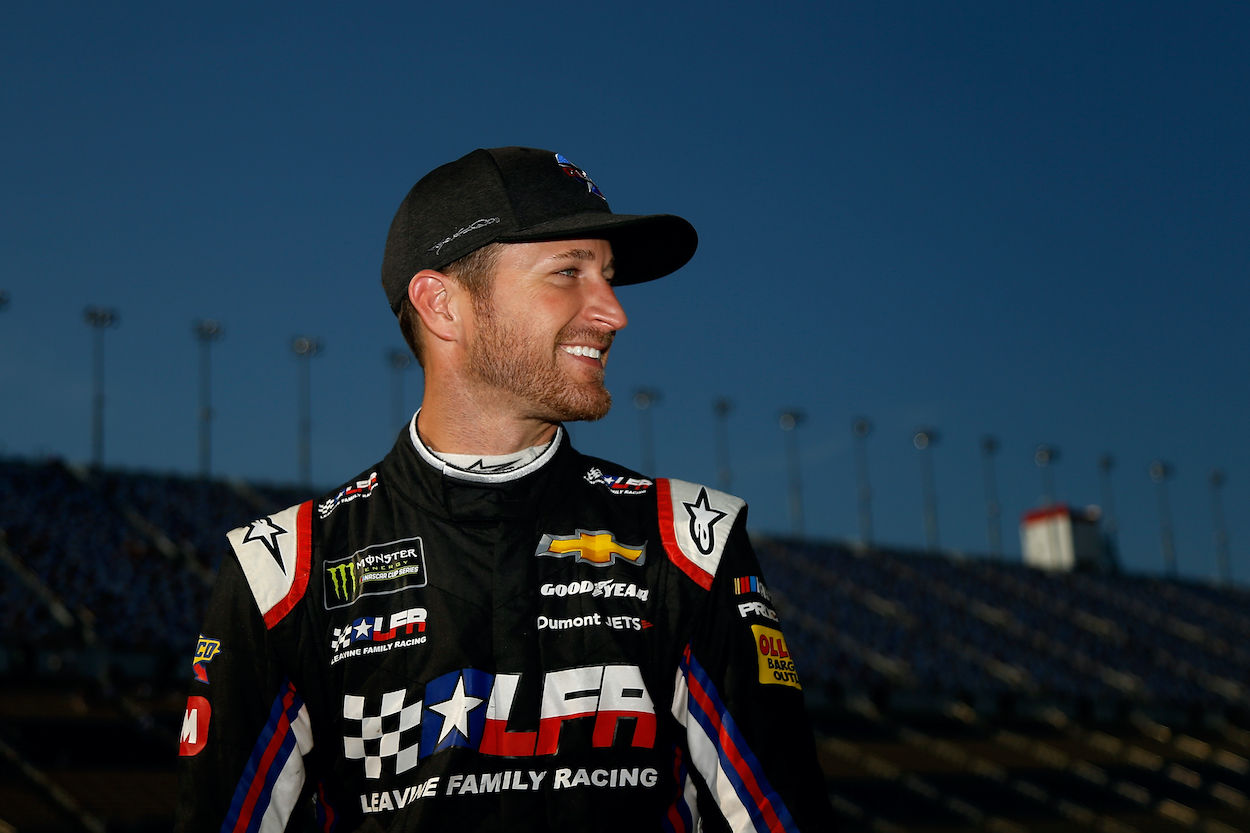 Kasey Kahne stands on grid