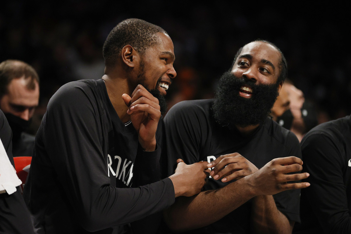 Kevin Durant laughs with James Harden of the Brooklyn Nets during a game